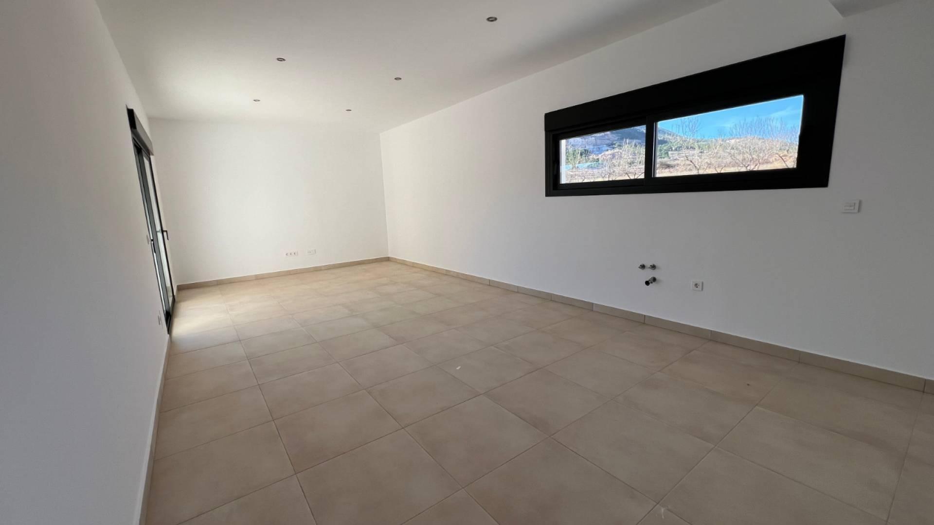 Window view from inside new-build villa looking out to 10,000m2 plot