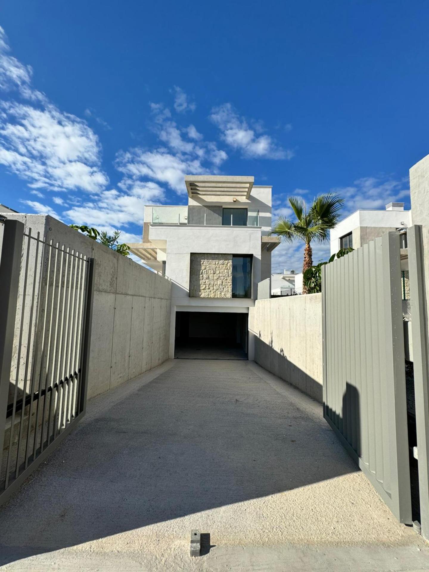 Living area with glazed doors open to terrace, new-build villa, Finestrat Hills