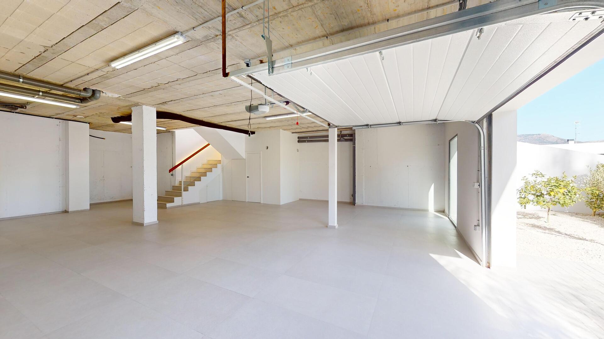 Open-plan living space in 293m² villa looking toward dining area, Pla de Cantal