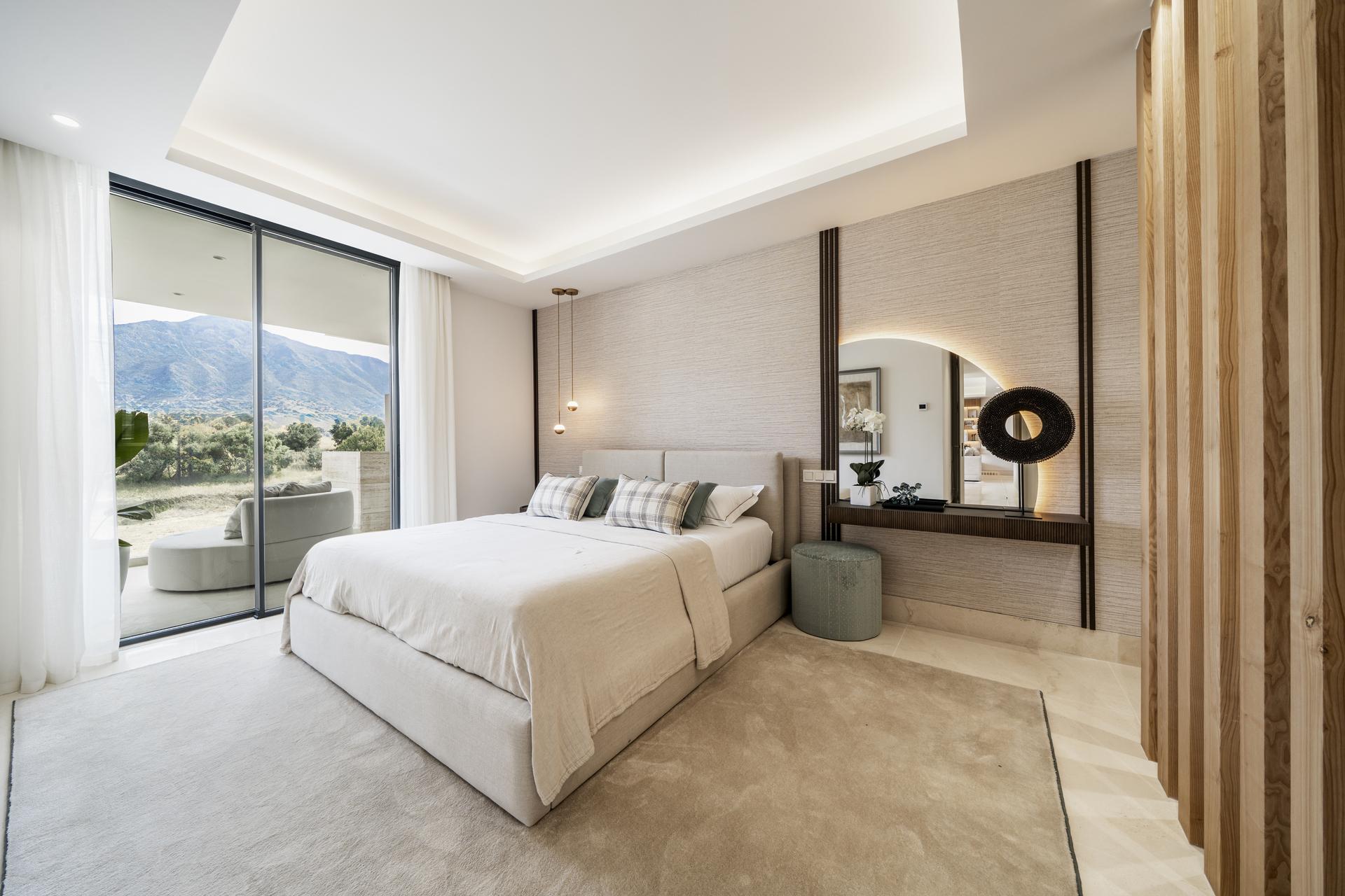 View from ground-floor terrace towards landscaped communal grounds, Aloha, Marbella