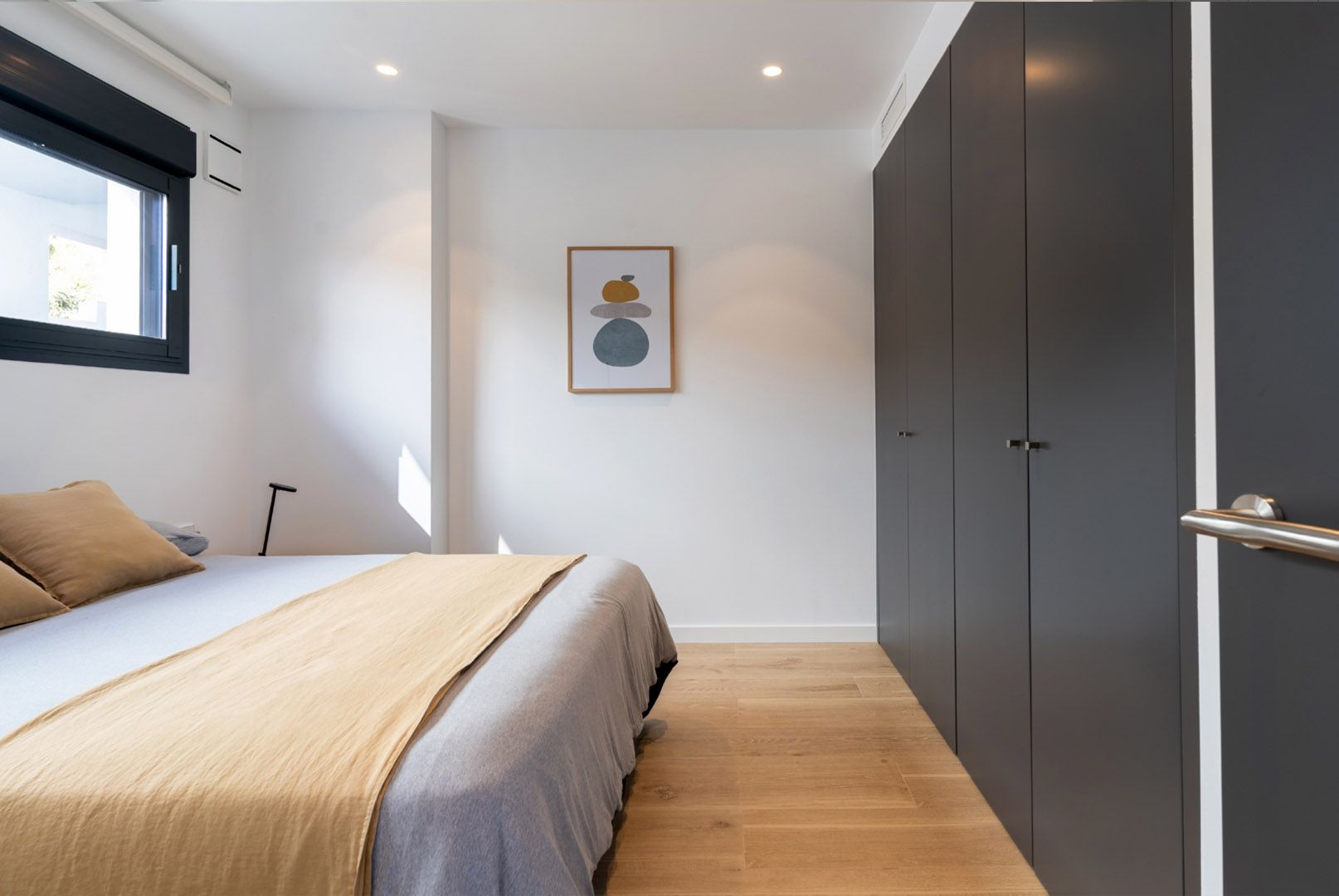 Master bedroom with built-in wardrobe and window