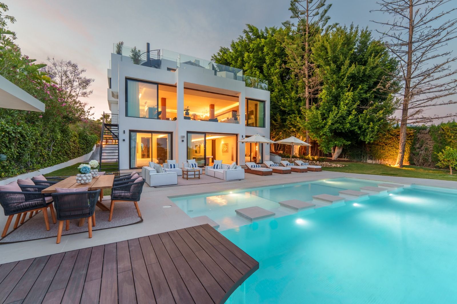 Terrace with dining furniture and garden views in new-build villa, Las Brisas, Marbella