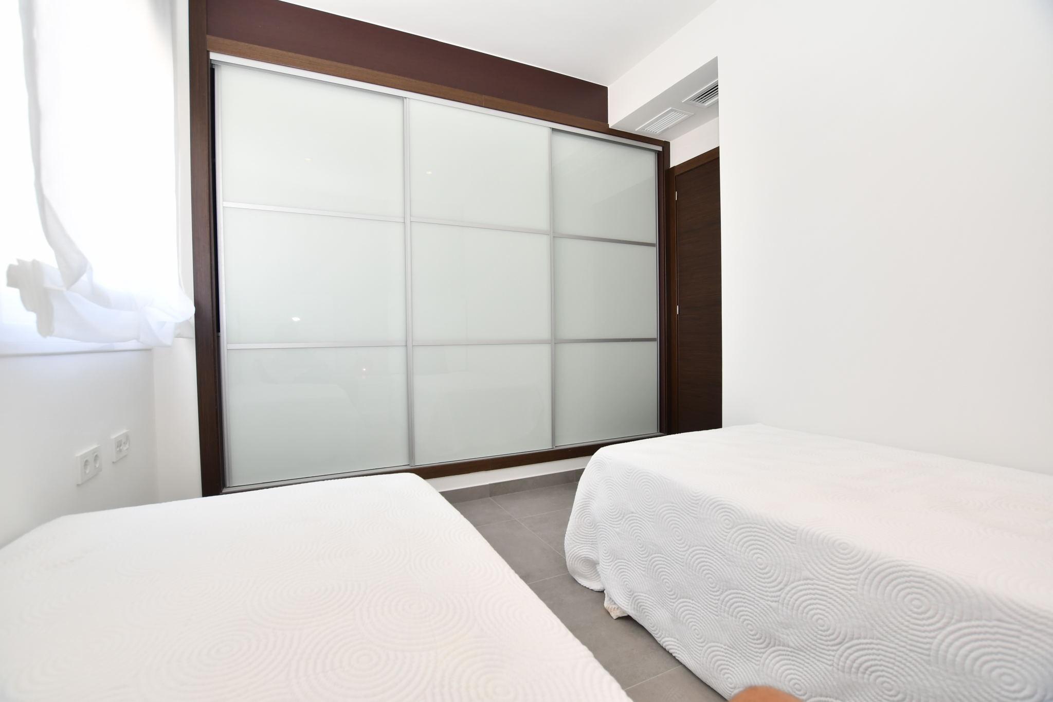 View of private garden through glass door in ground-floor apartment, Bellavista, San Miguel De Salinas