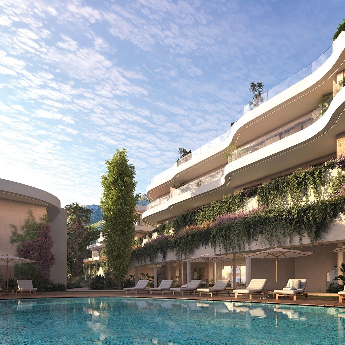 Communal pool with landscaped gardens in gated El Higuerón development, Fuengirola
