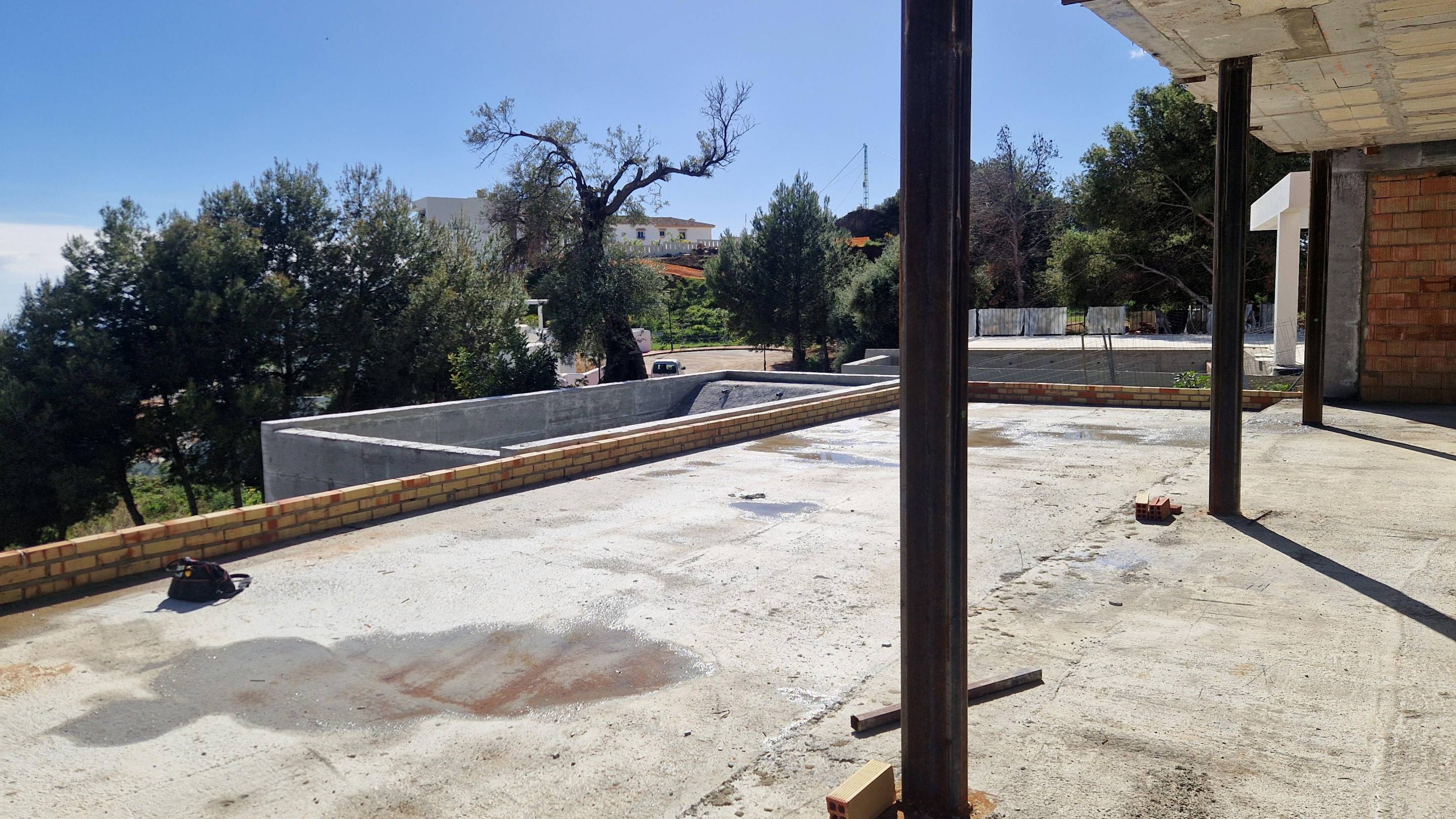 Covered outdoor terrace in 5-bedroom new-build villa, Mijas Pueblo, with seating area and garden outlook