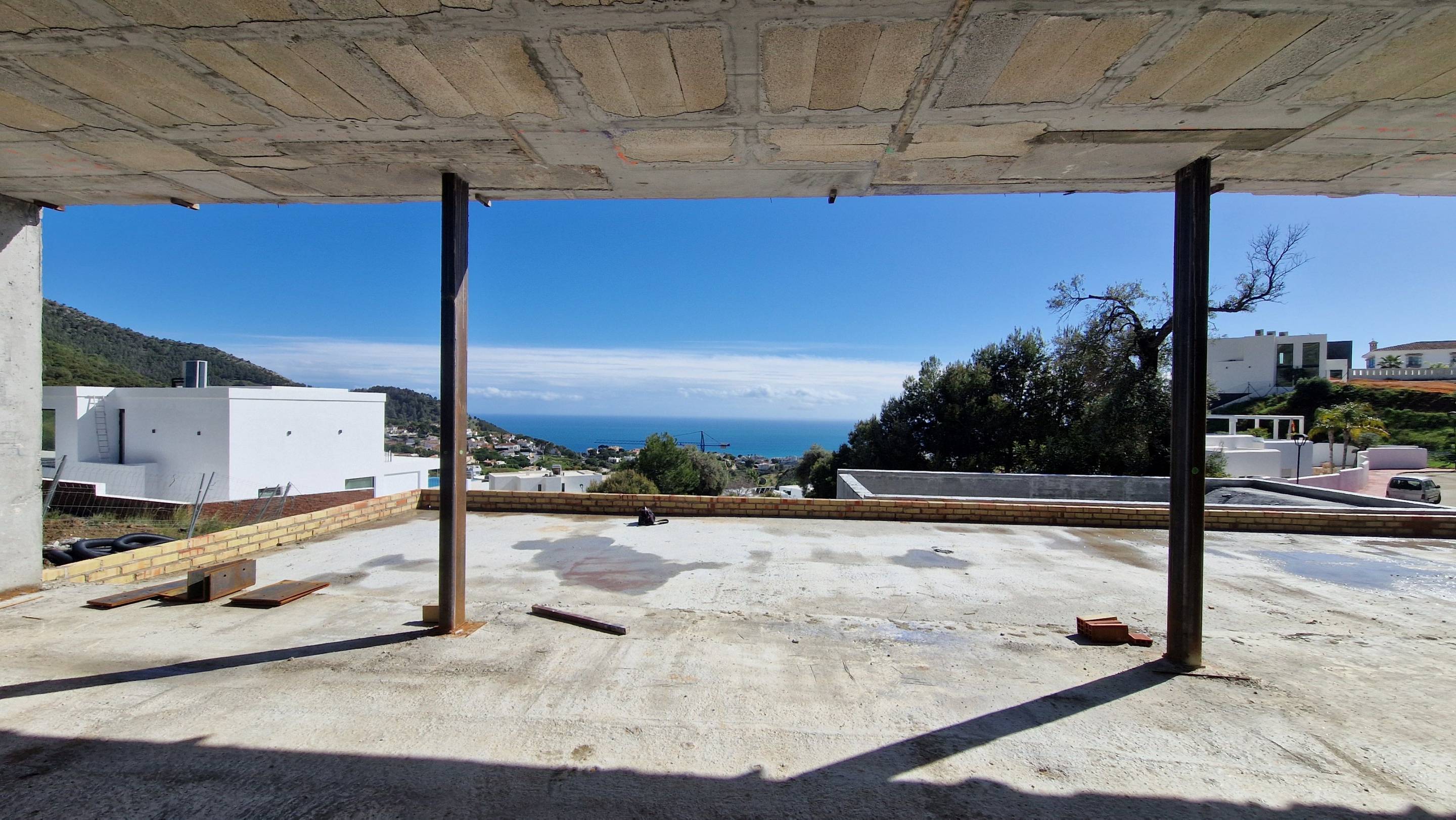 Rear garden of new-build villa in Mijas Pueblo with landscaped ground and boundary wall