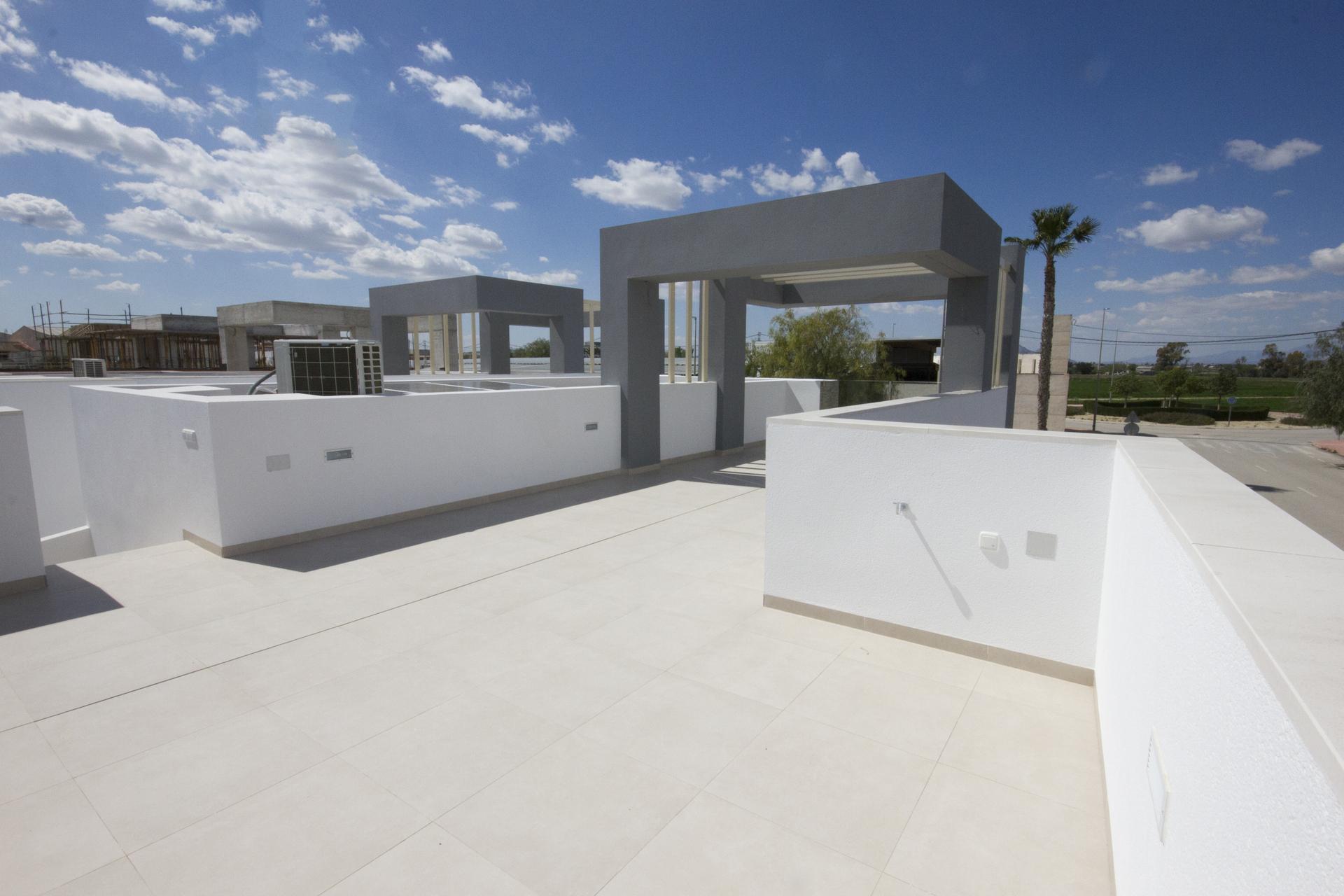 Shaded outdoor seating area under pergola, new-build bungalow, San Fulgencio Pueblo