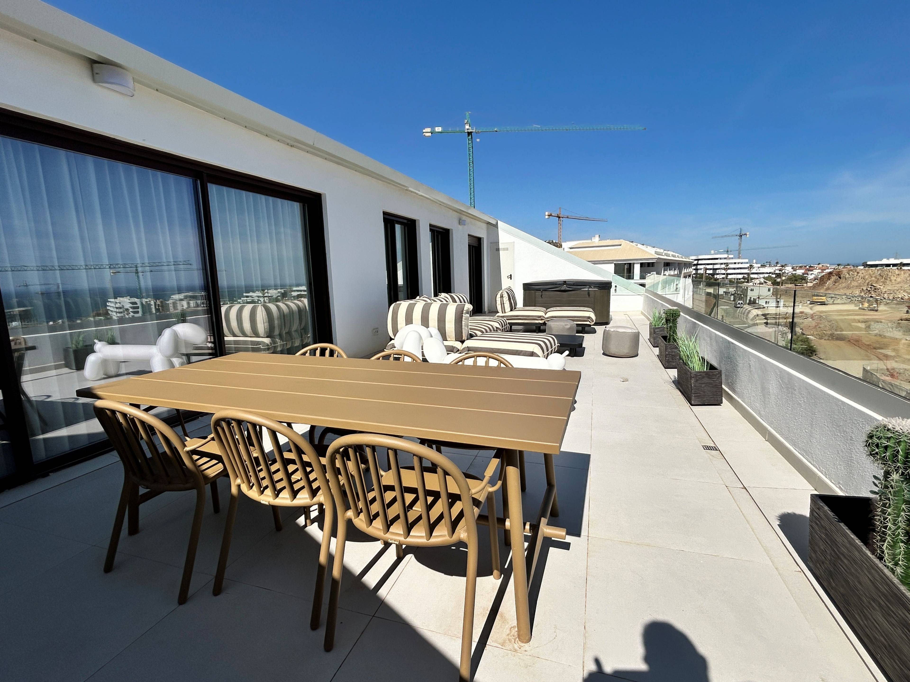 Kitchen with island and integrated appliances, alternate angle, new-build penthouse, El Higuerón