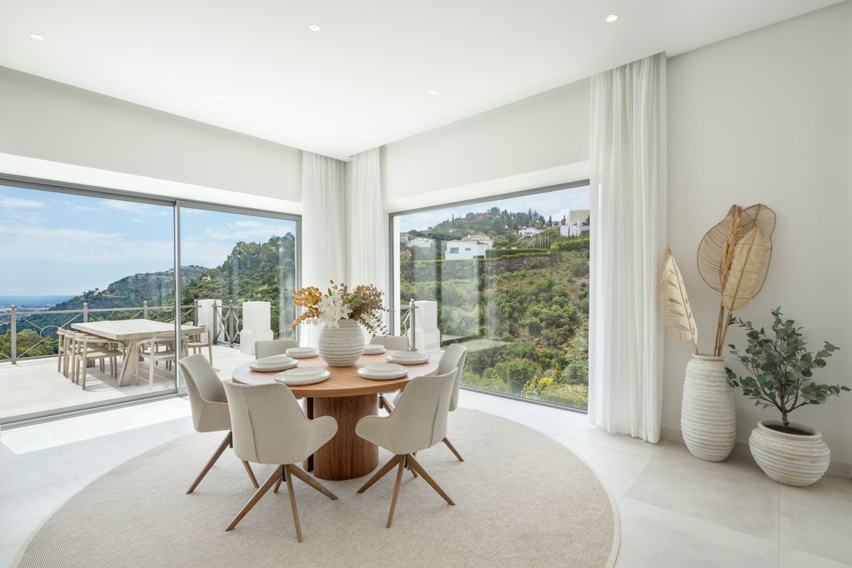 Dining area adjacent to glazed wall in new-build villa, La Zagaleta-El Madroñal, Benahavis
