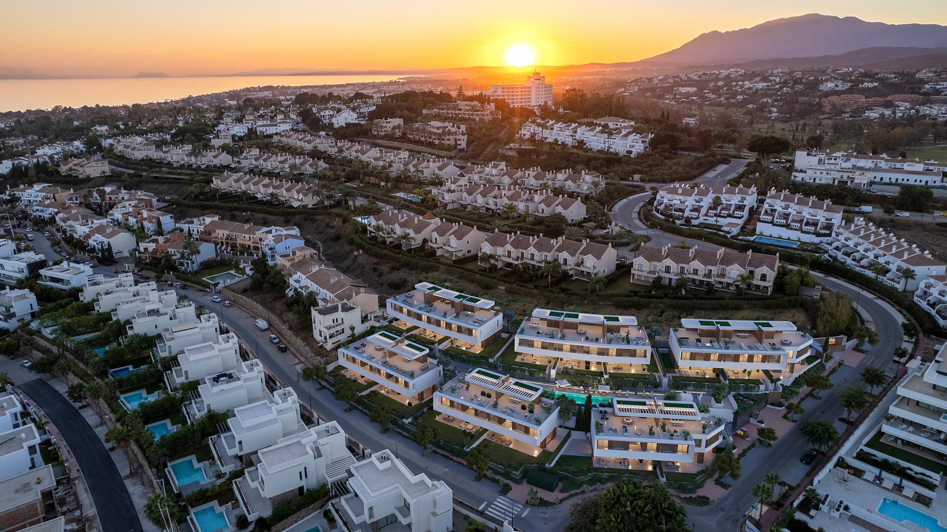 Communal pool and surrounding paved area within new-build villa development, Estepona