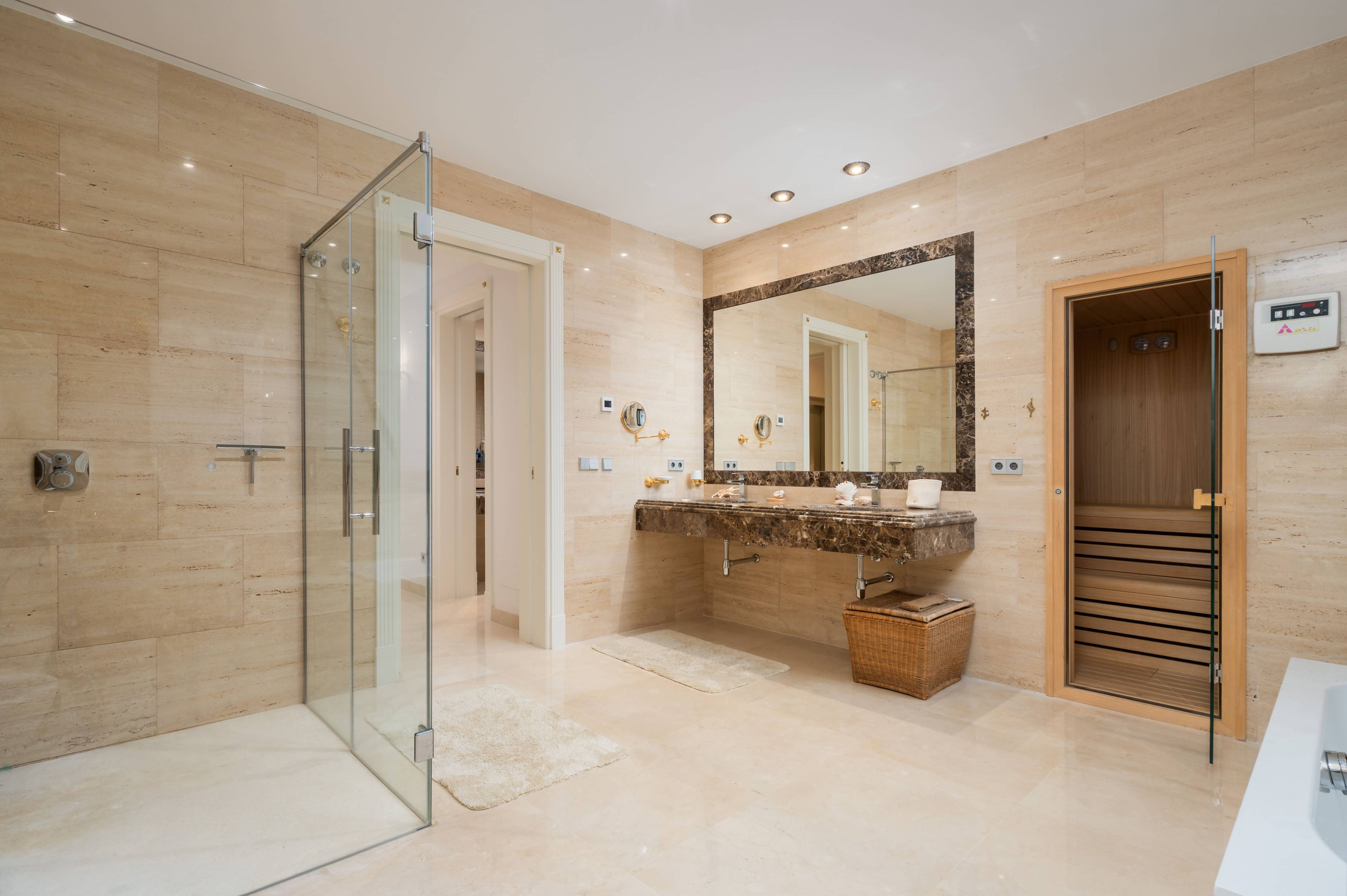 Living room with floor-to-ceiling glazing overlooking garden, Casasola villa