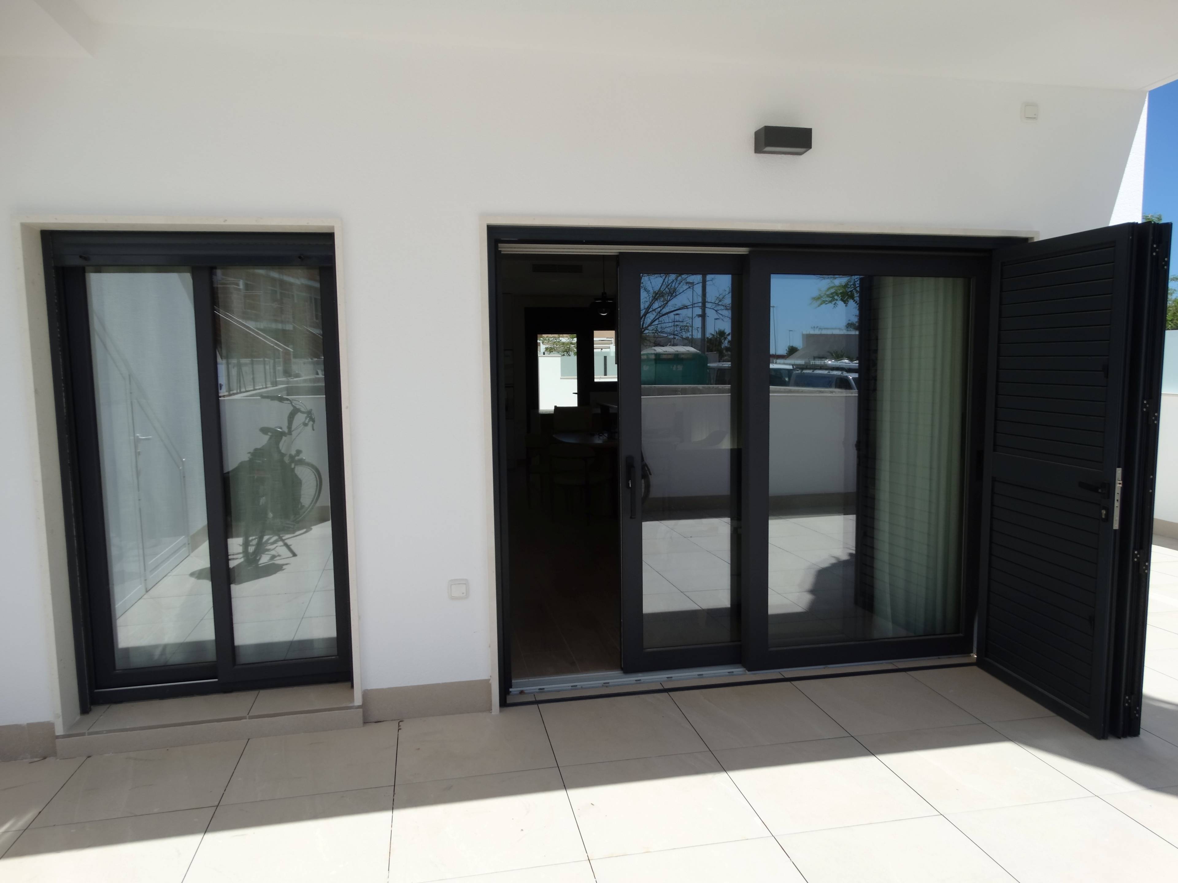 Communal pool and surrounding paved terrace in new-build complex, Zona Pueblo