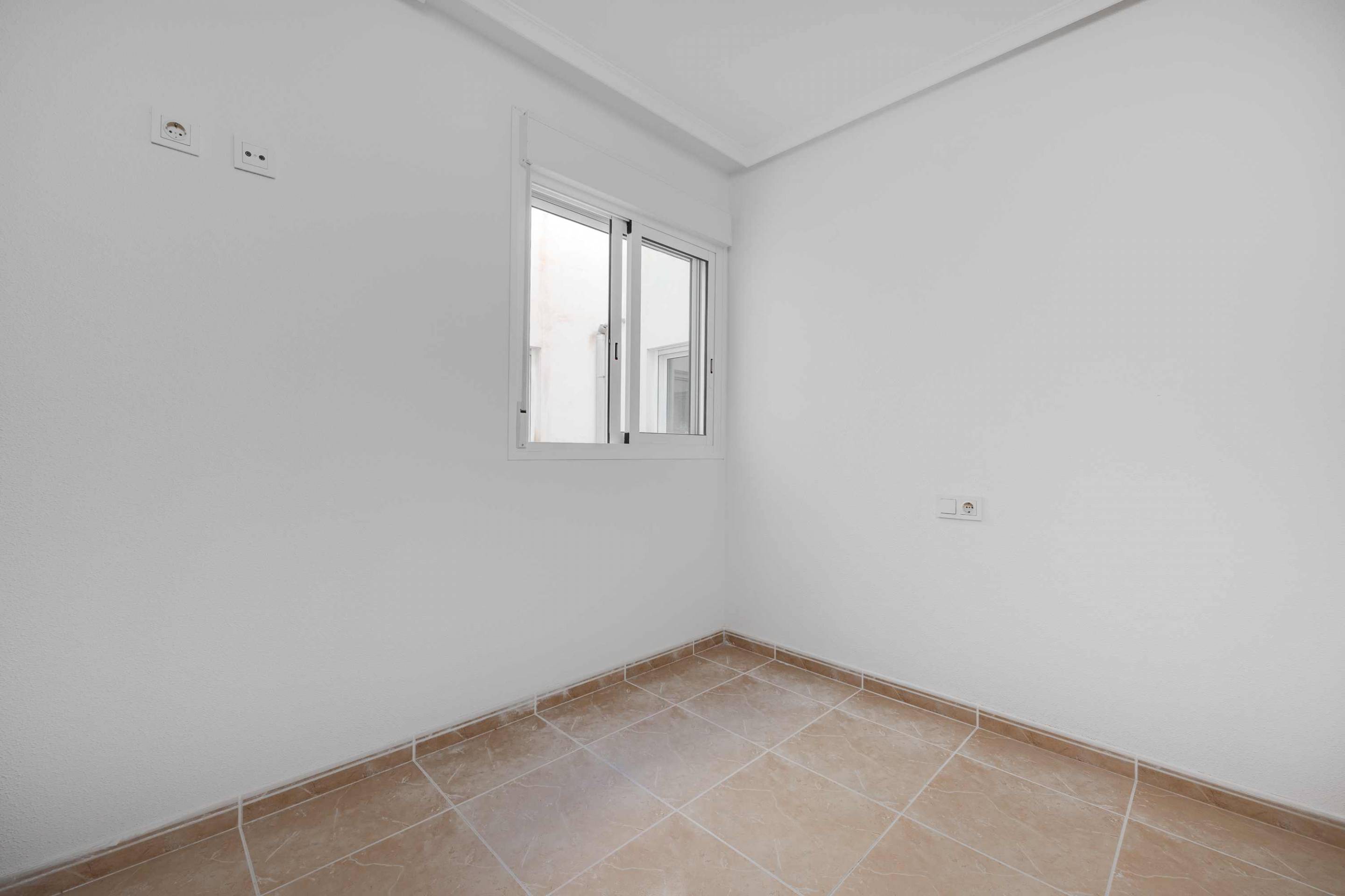 Bedroom with fitted wardrobe doors in new-build apartment, San Fulgencio Pueblo