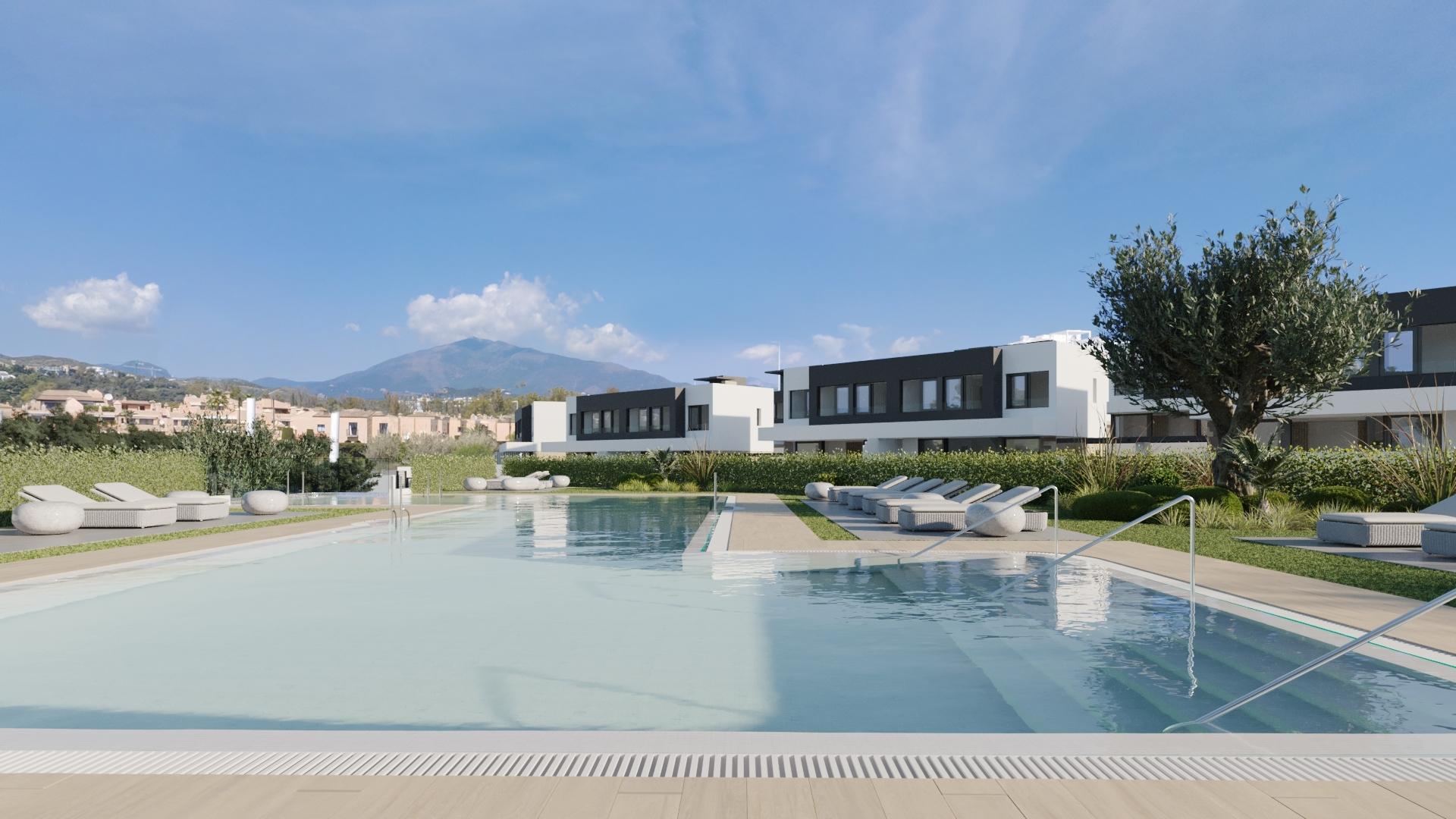 Communal pool and landscaped grounds in Estepona townhouse complex