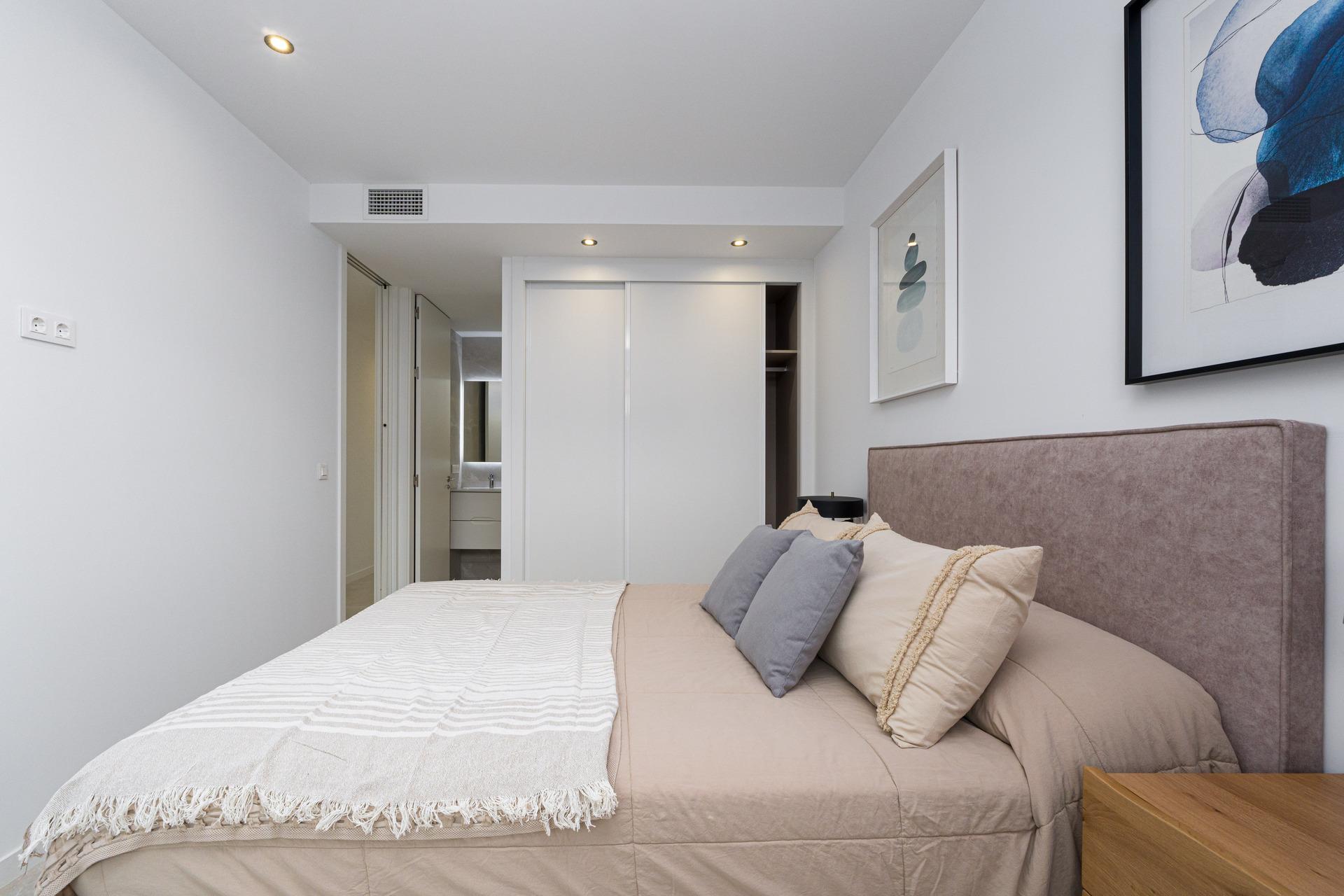 Bedroom with natural light through full-height window, penthouse, Camporrosso Village, Finestrat
