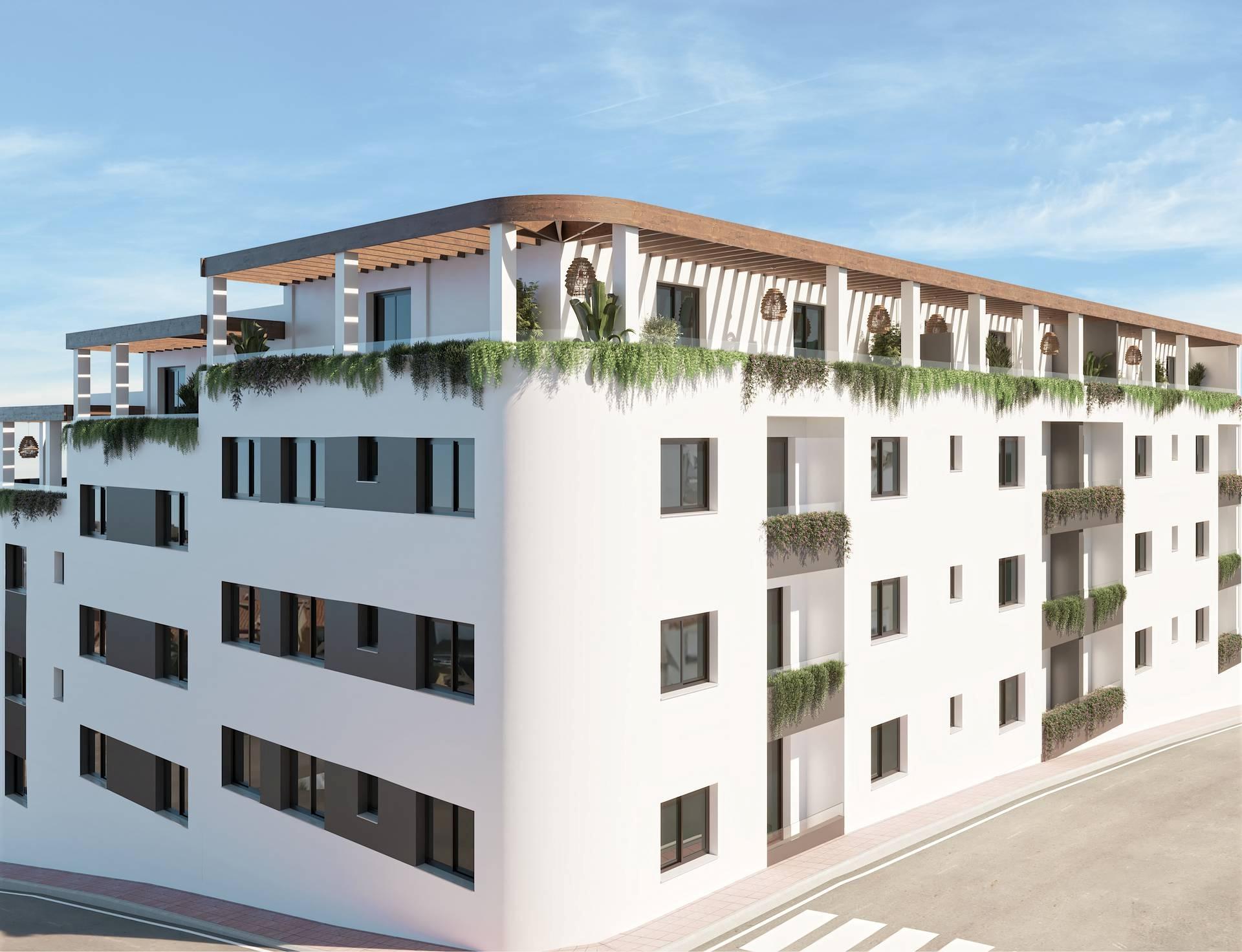 Evening exterior view of new-build apartment block with lighting, Las Flores, Mijas