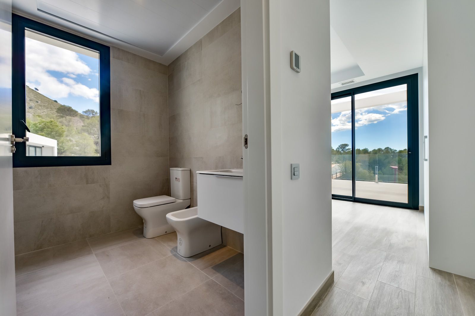 Living room with open terrace doors in Golf Bahía villa, Finestrat