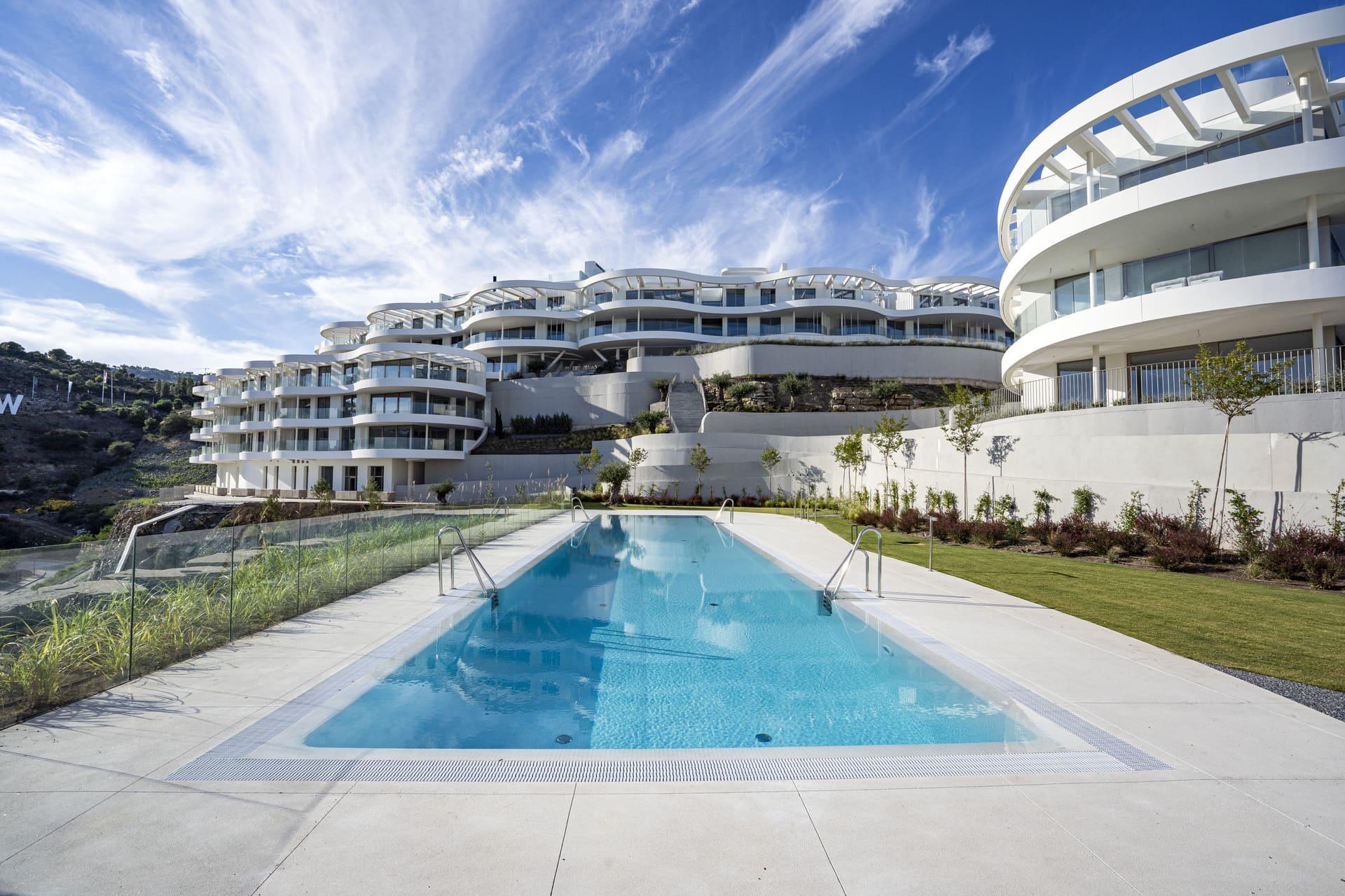 Development exterior facade at dusk, new-build apartment block, La Quinta, Benahavis