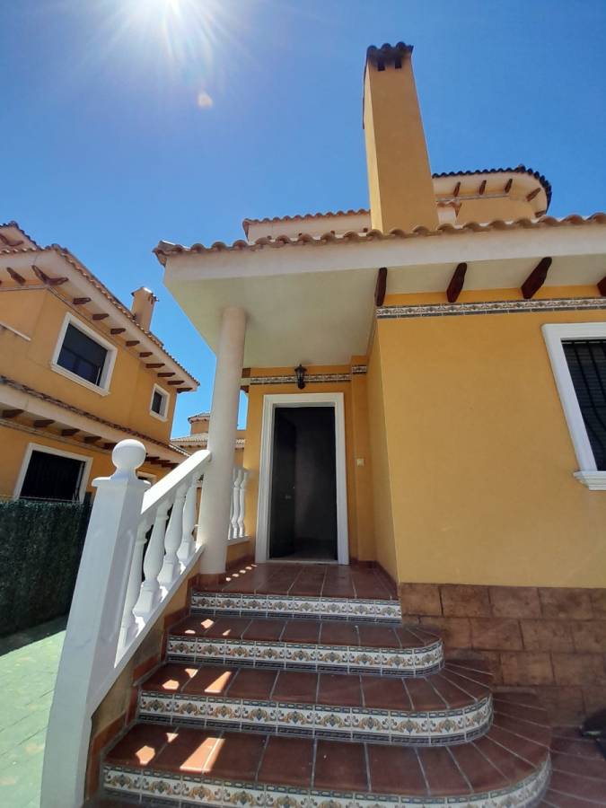 Side exterior view of detached villa showing boundary wall and plot, Lo Marabú