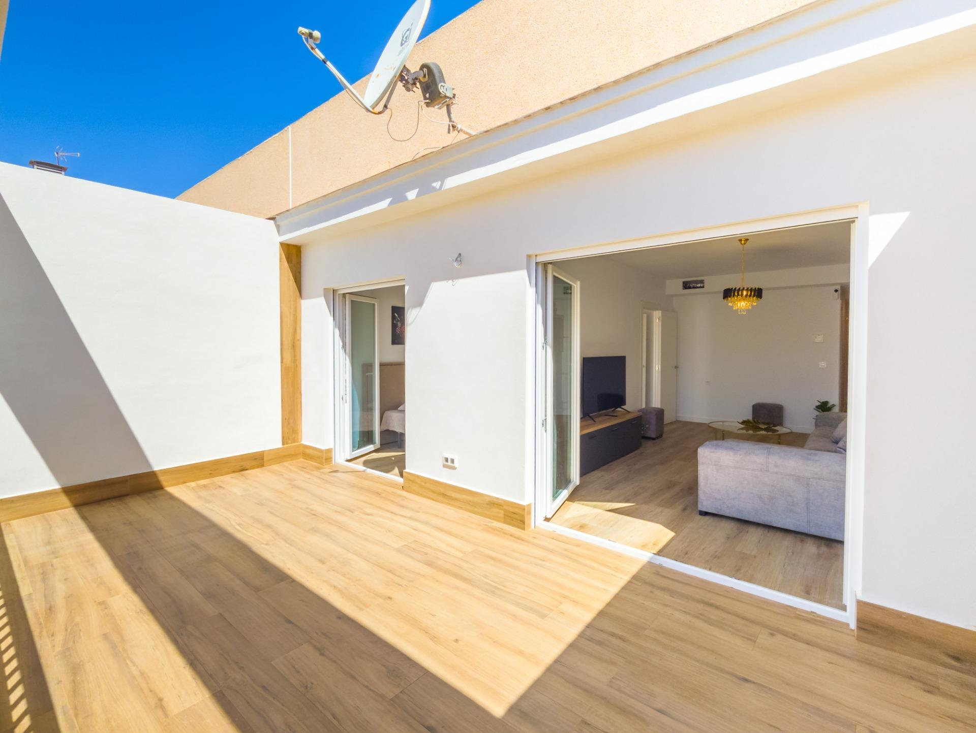Open-plan kitchen and dining area with new appliances, apartment in Playa del Cura