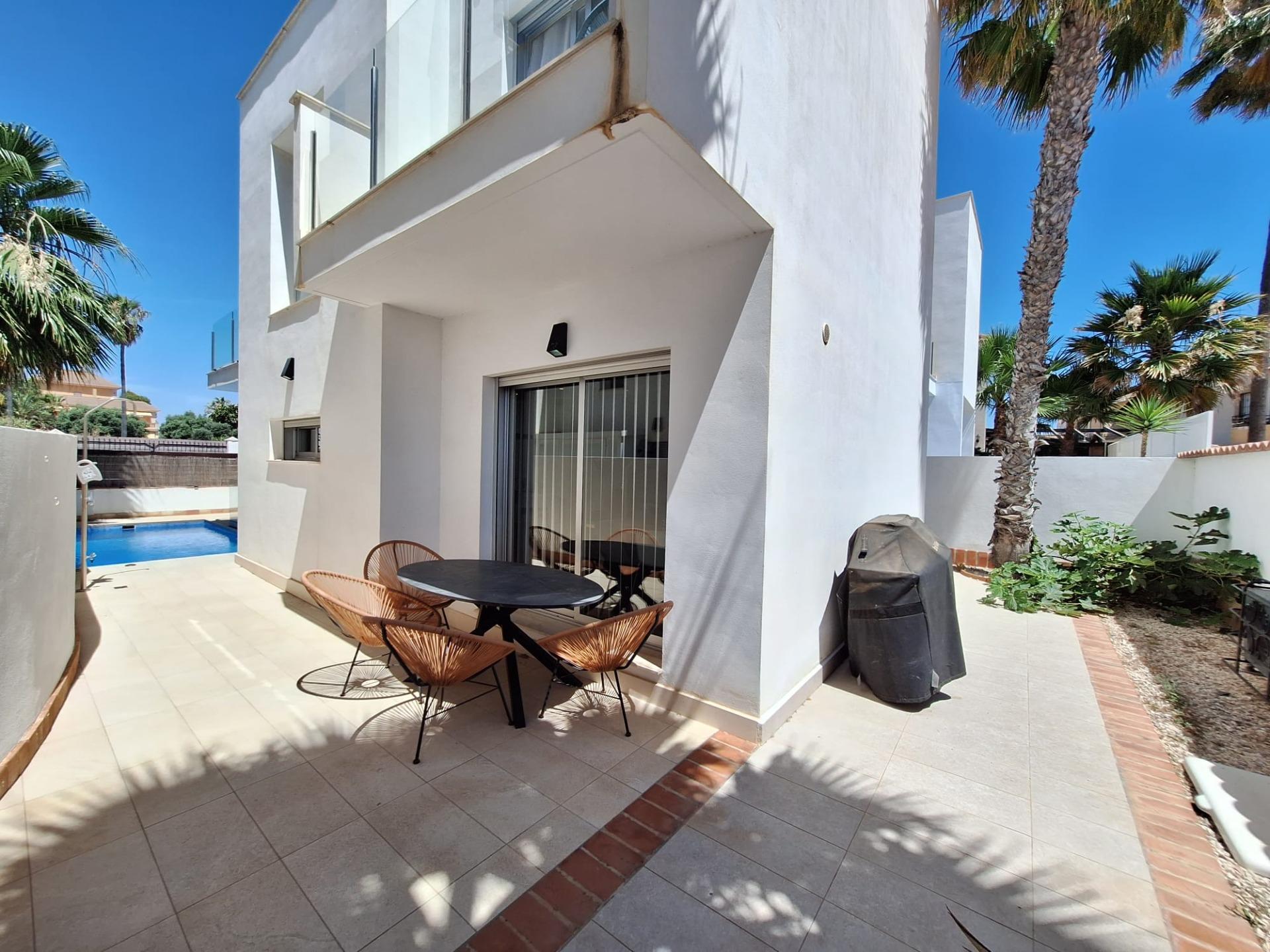 Rear garden and patio area of detached villa in Los Frutales, Torrevieja