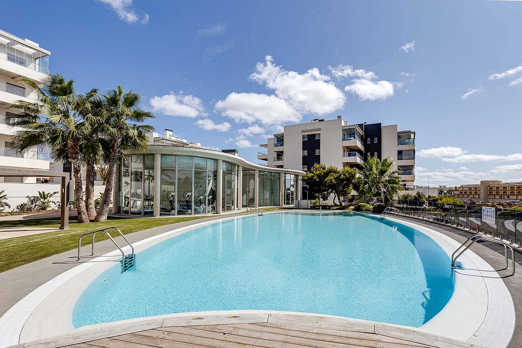 Glazed terrace with sofa and dining table, ground-floor apartment, Los Dolses