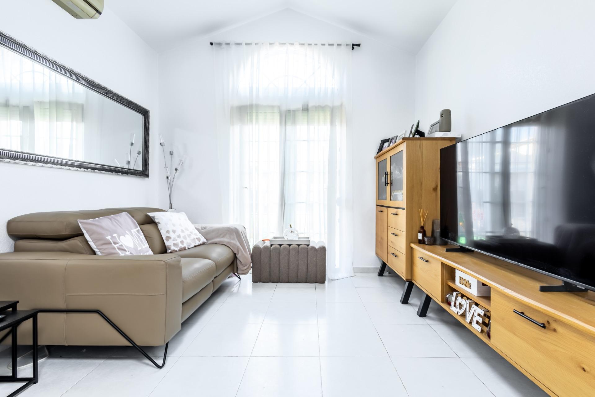 Enclosed utility area with skylight used as dining and laundry space, La Siesta townhouse
