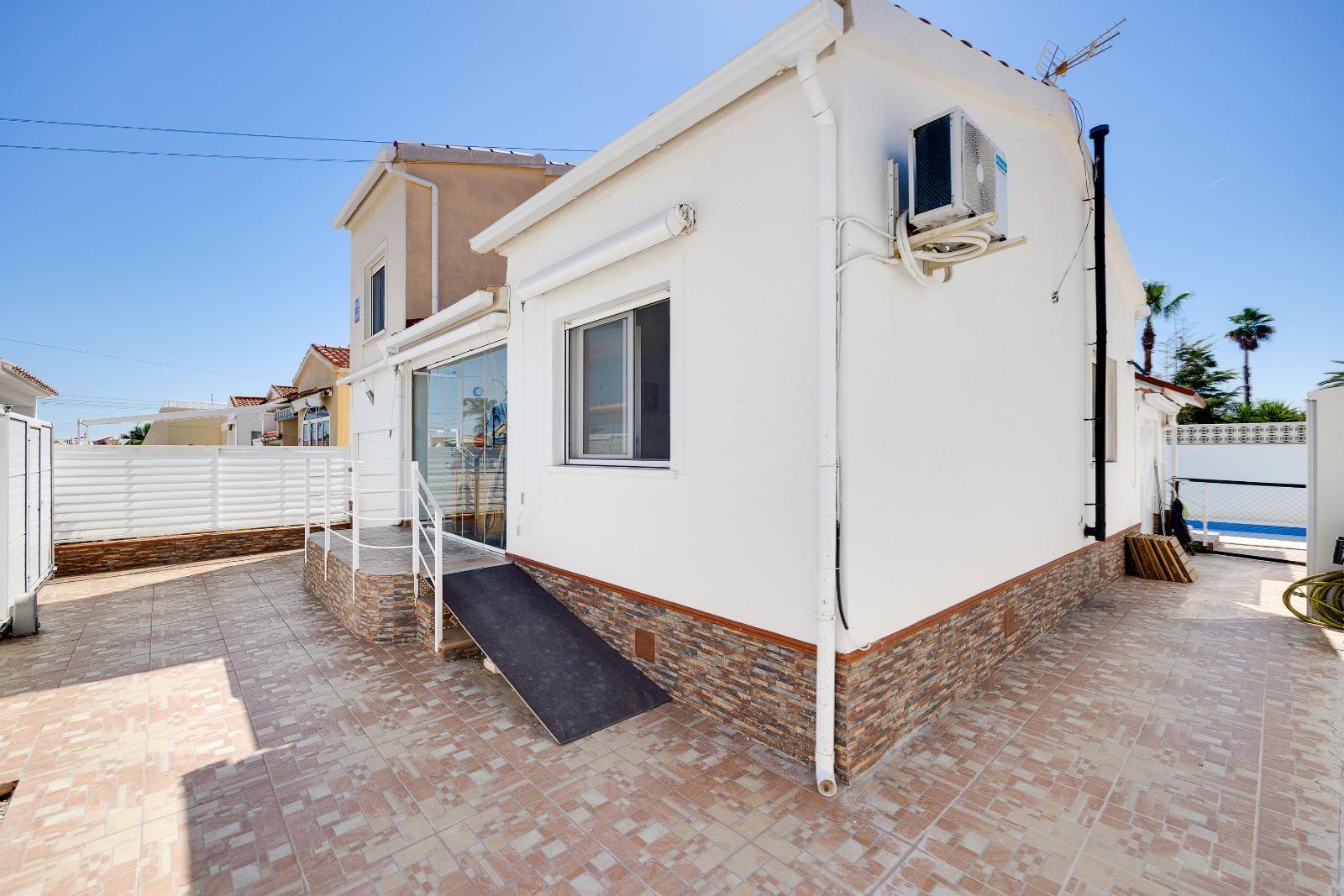 Rear exterior of villa showing outdoor space and plot boundary, La Marina