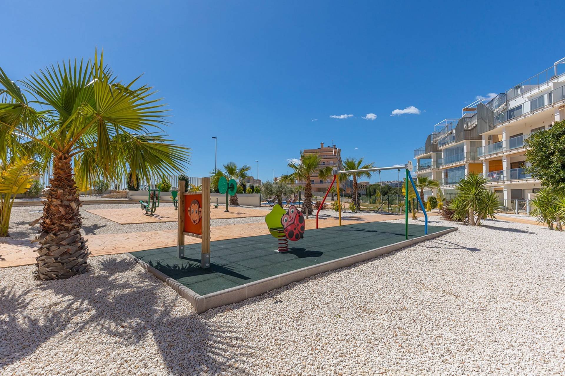 Communal seating area within gardens, Los Dolses complex