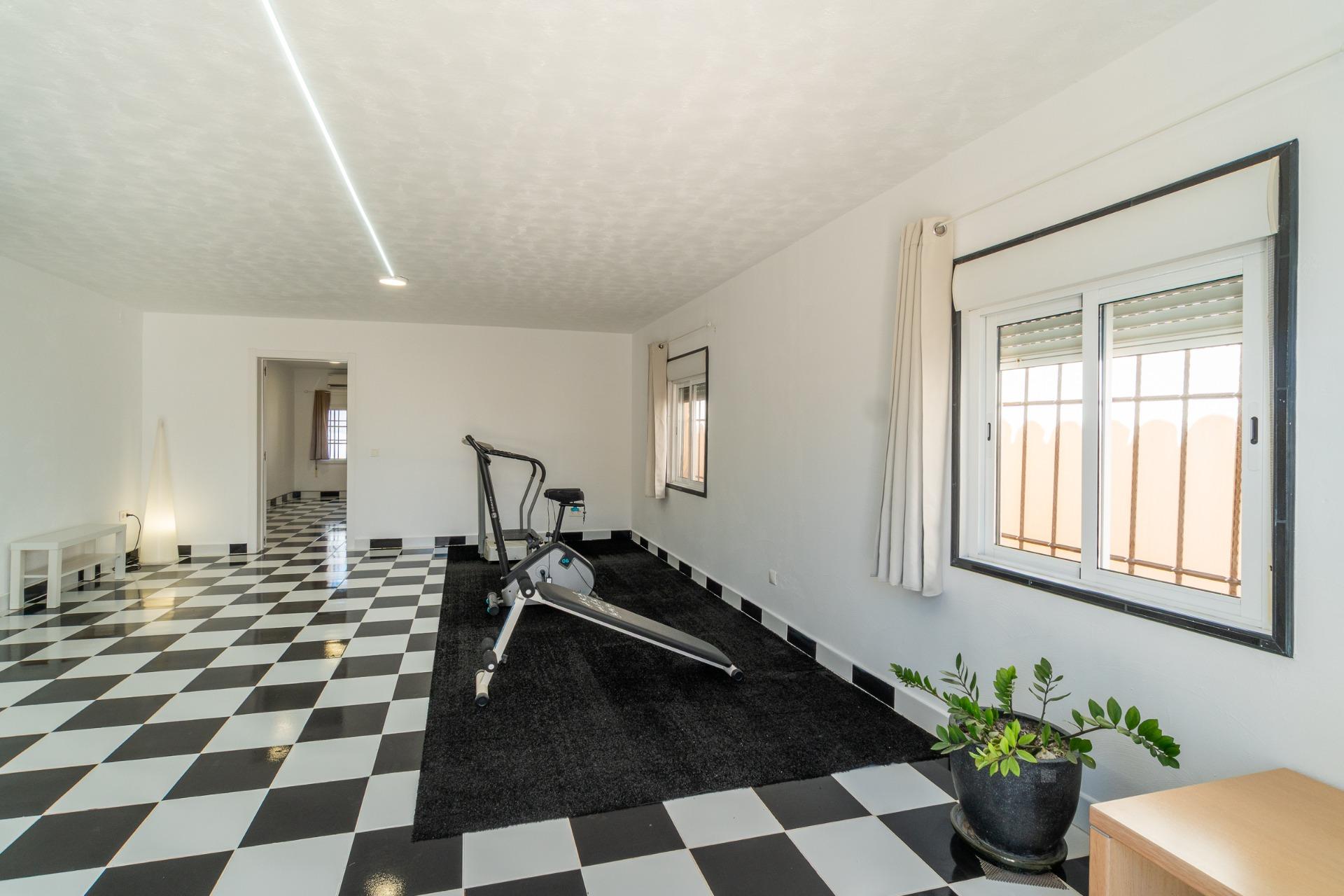 Exterior wall and gated entrance detail, villa in Torreta Florida, Torrevieja