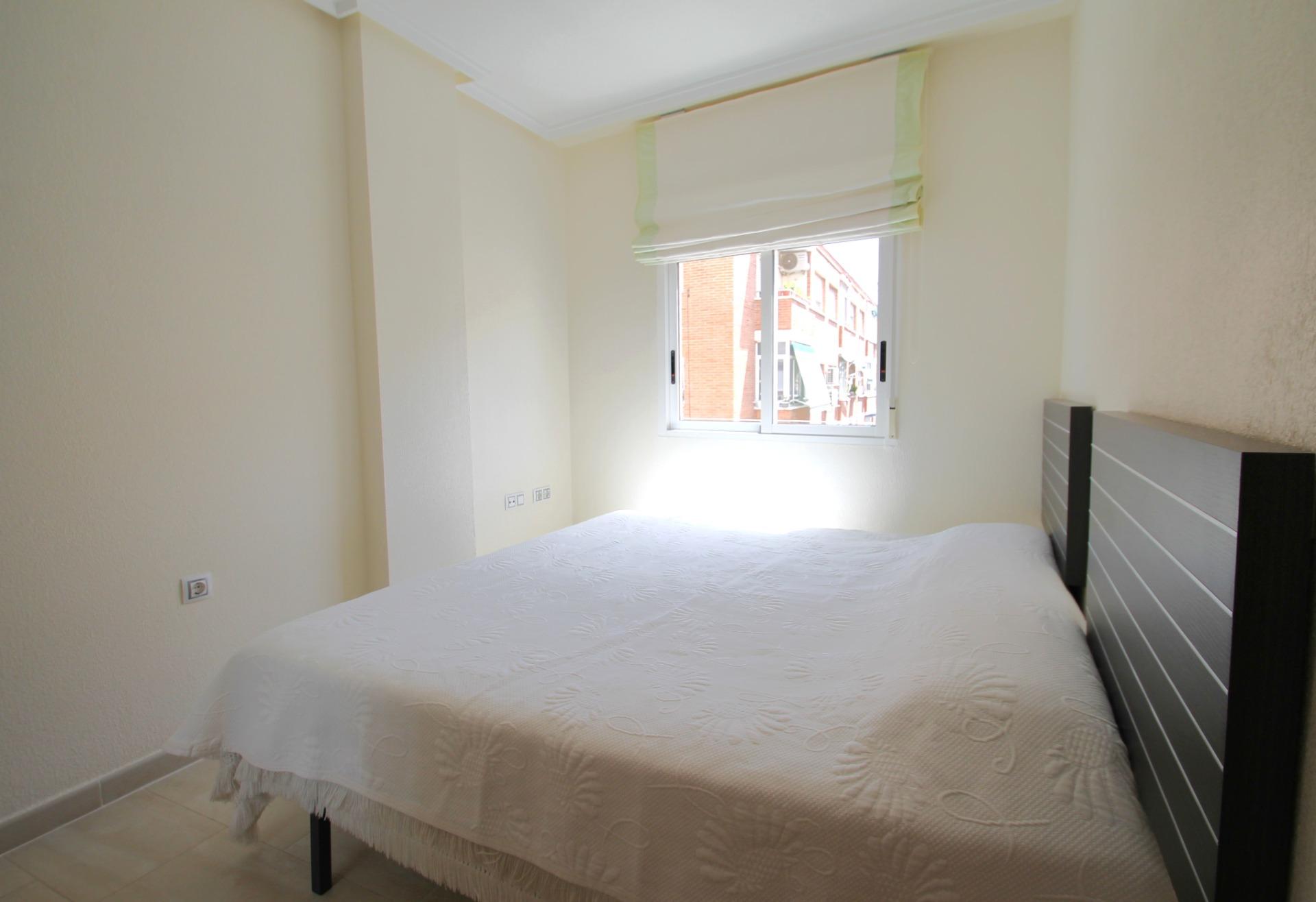 Living room seating area with natural light in 2-bedroom apartment, El Molino