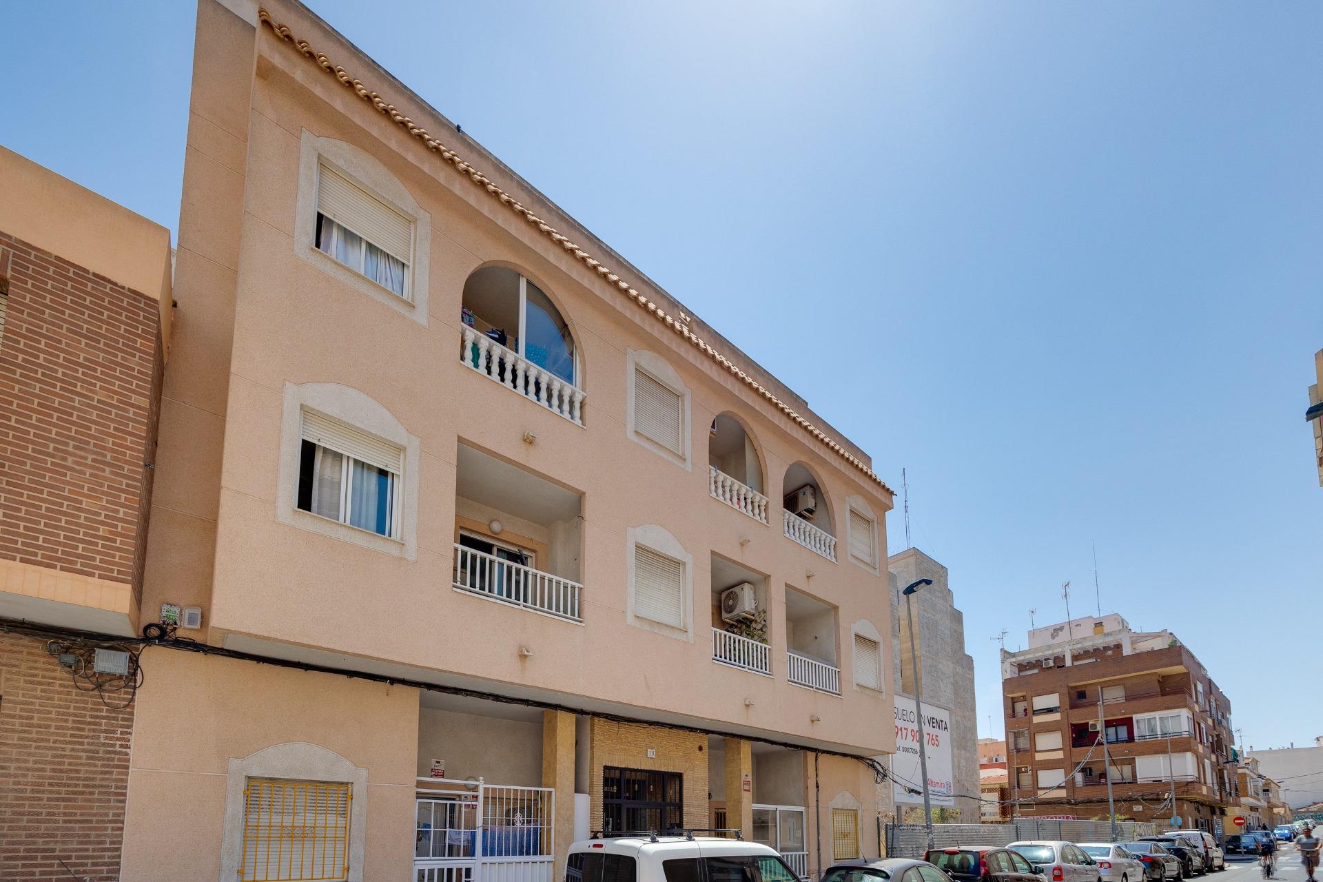 Communal pool area and surrounding terrace in residential complex, El Molino