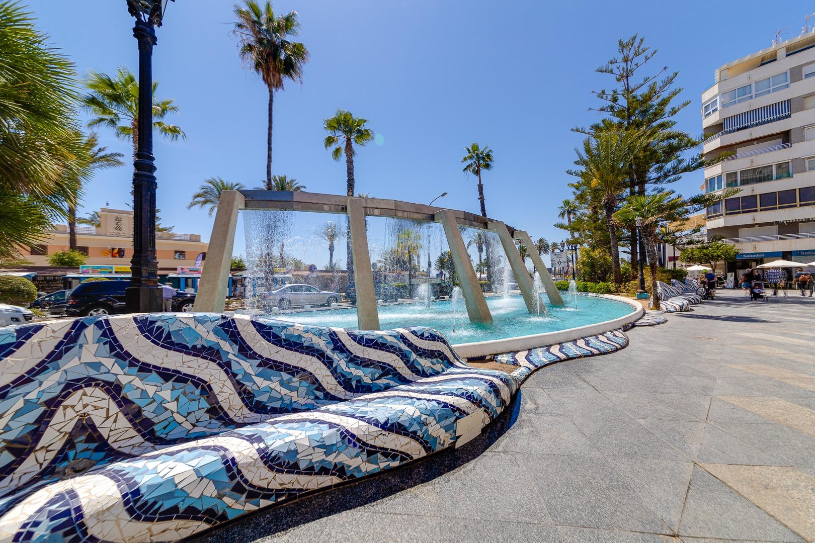 Communal garden area surrounding pool in residential complex, El Molino