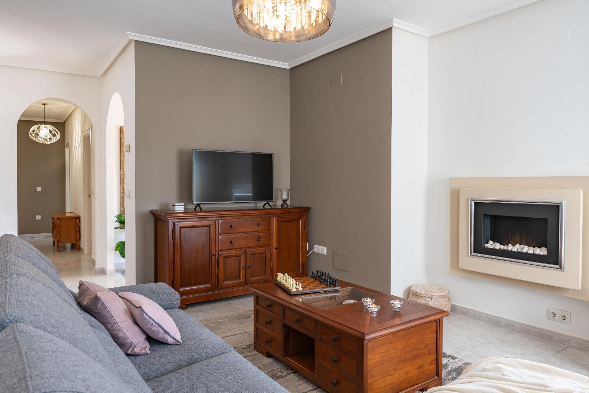 Living room seating area with south-facing windows, single-storey villa, Playa Flamenca