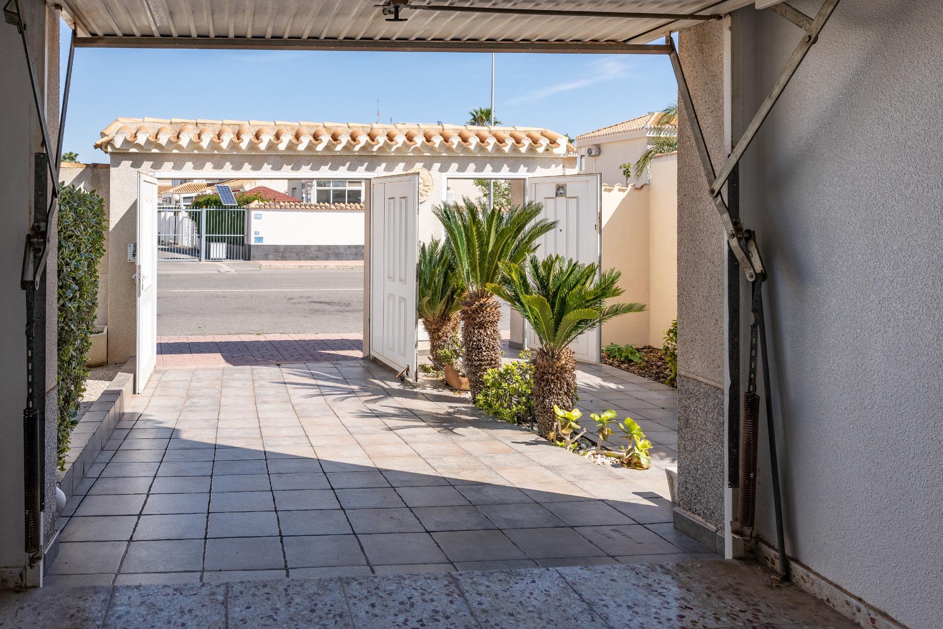 Street-facing front facade of villa in central Playa Flamenca, Orihuela Costa