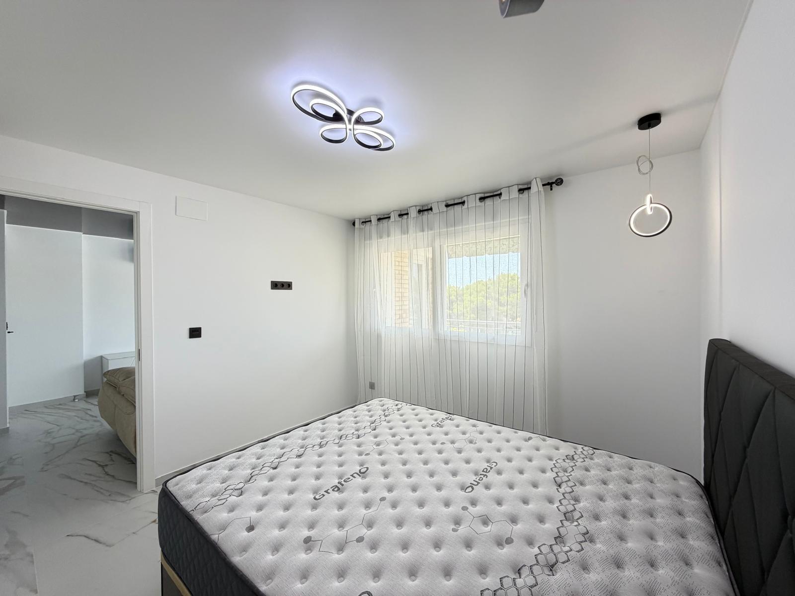 Living area with updated ceiling lighting in La Zenia apartment