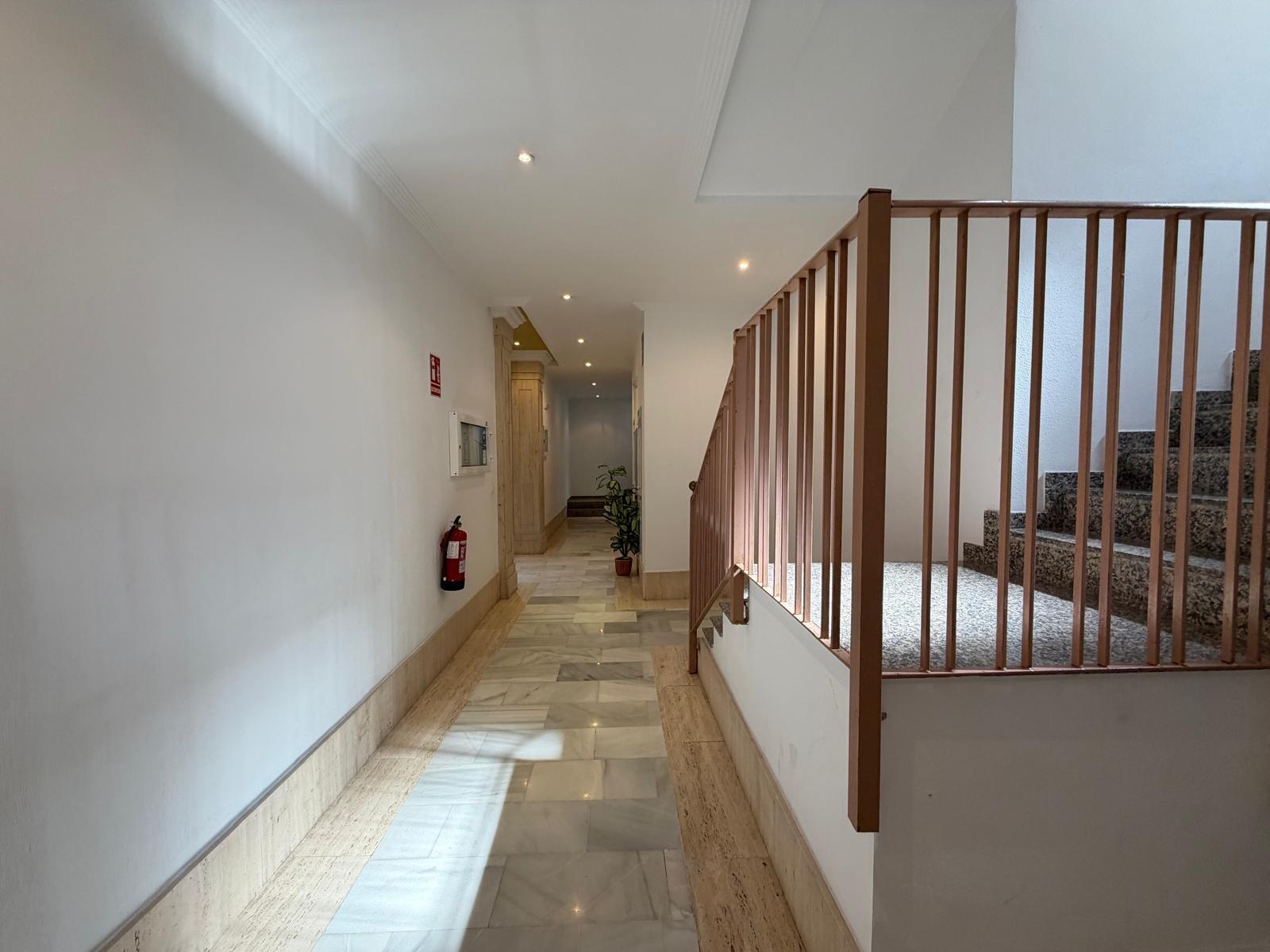 Dining table and chairs in open-plan area, penthouse Playa del Cura