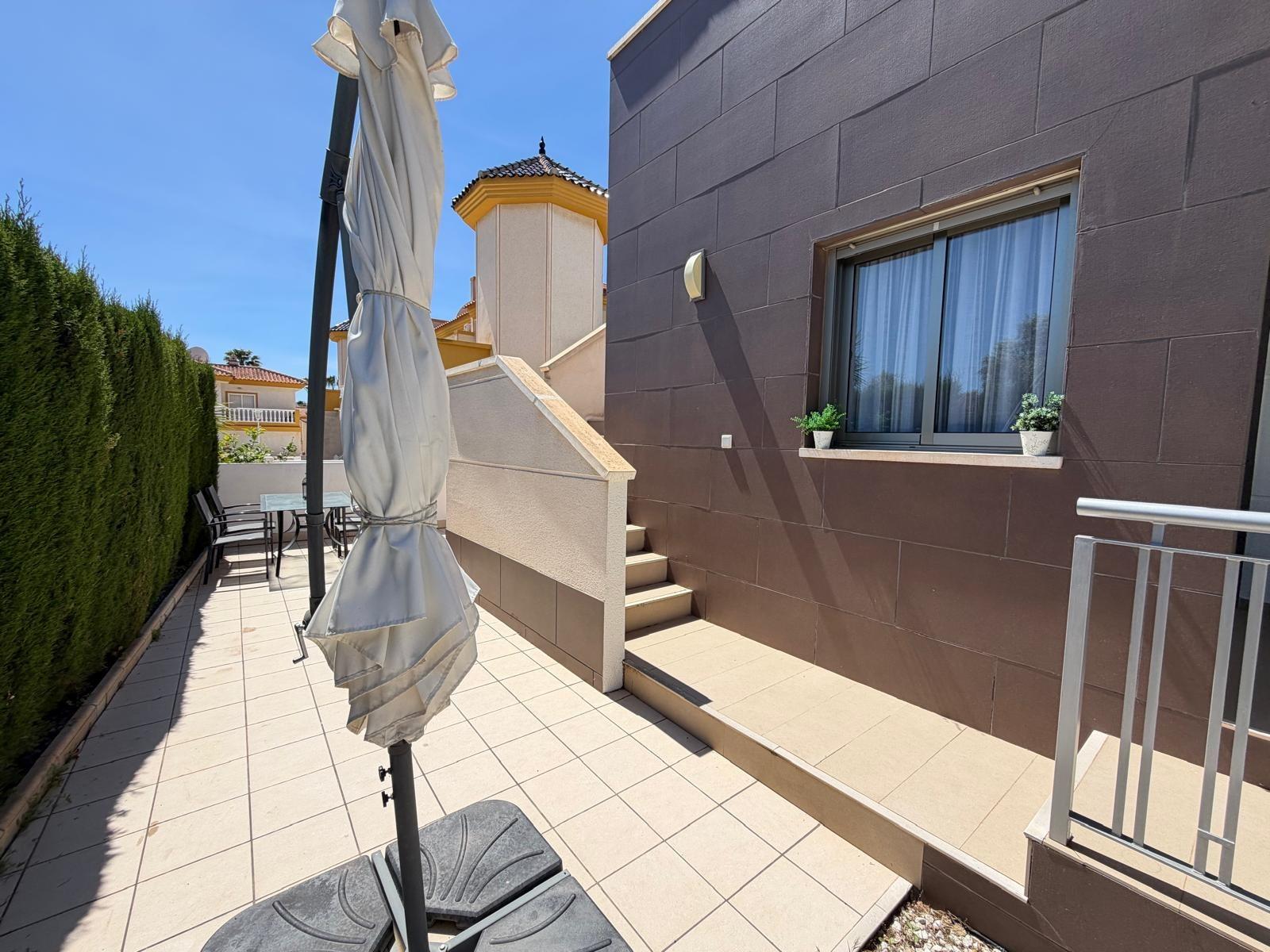 Terrace with outdoor furniture and garden view, villa in Doña Pepa