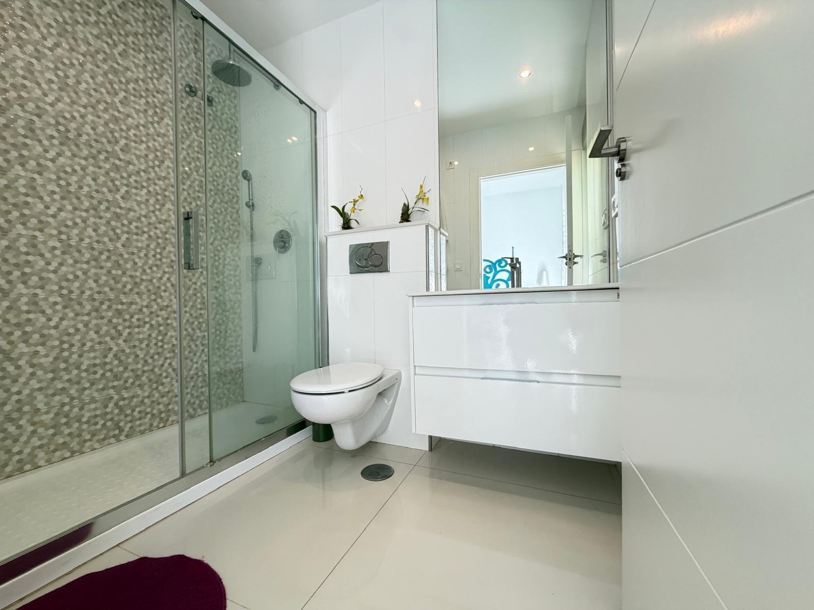 Bathroom with mirrored cabinet above basin, villa in Doña Pepa