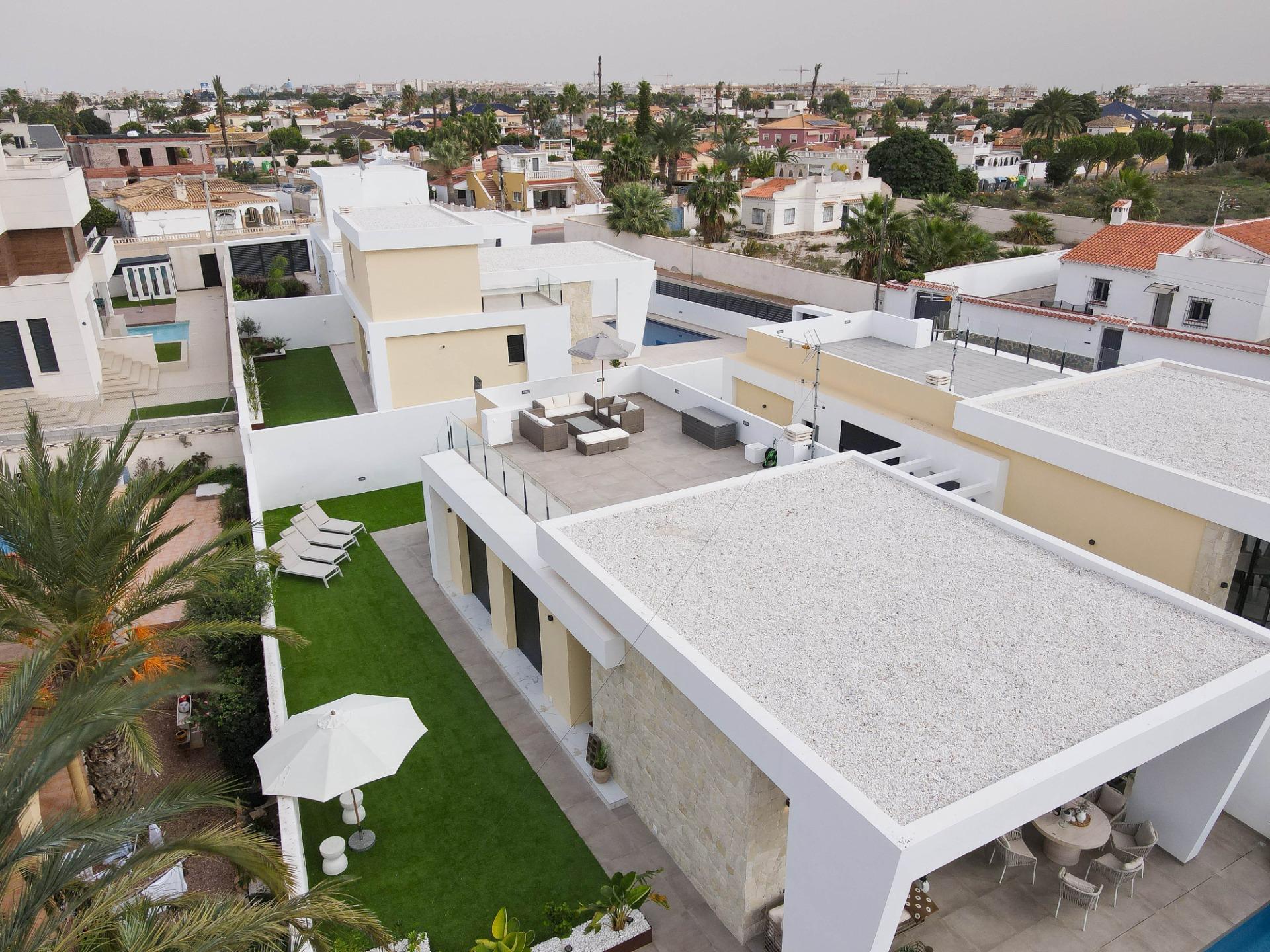 Terrace at sunset with pool and deck in foreground, La Siesta villa