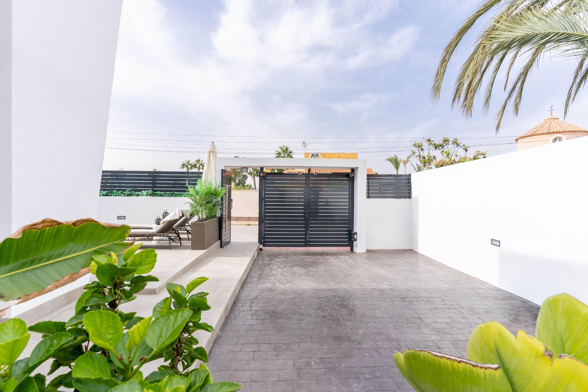 Dining area with floor-to-ceiling sliding doors open to terrace, La Siesta villa
