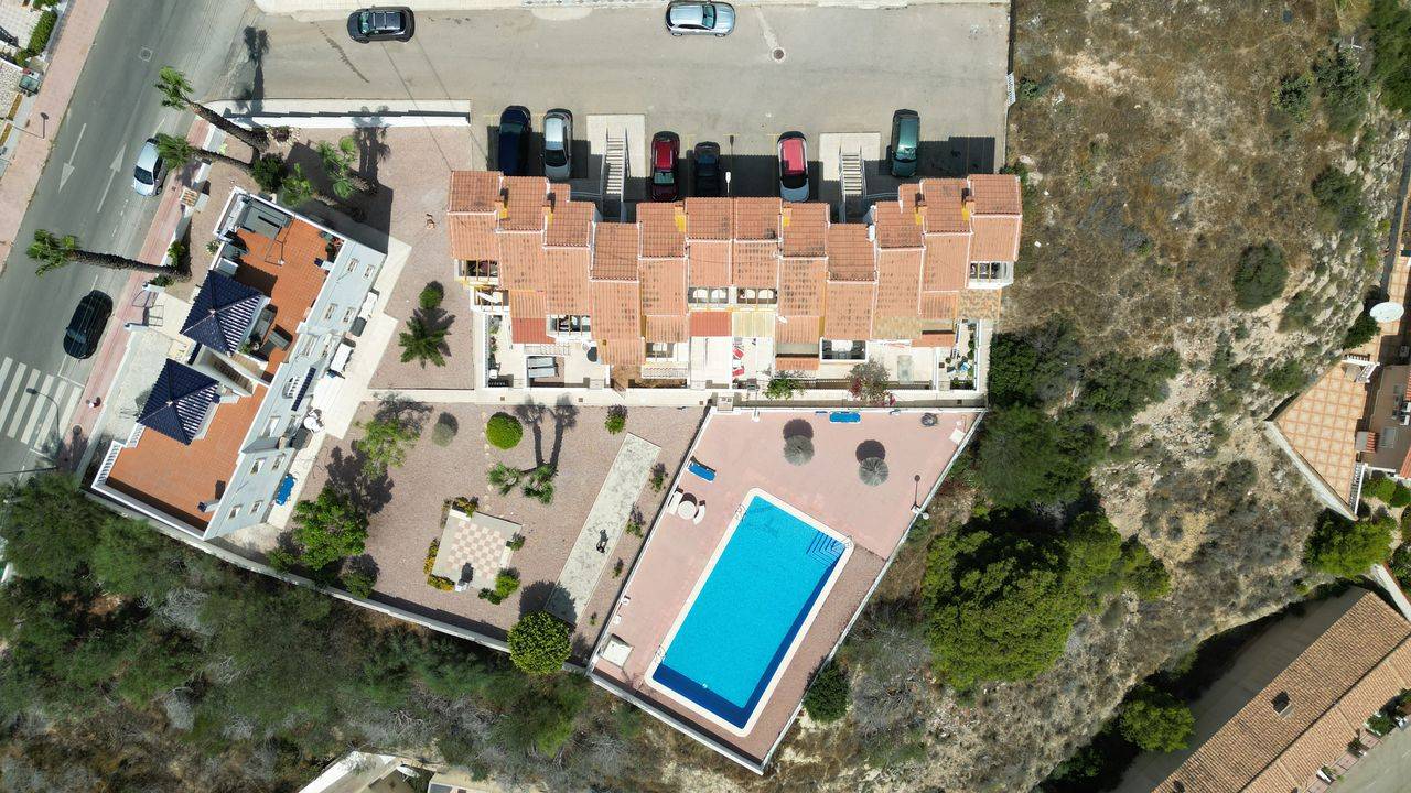 Poolside communal area with seating in apartment complex, Rojales Hills