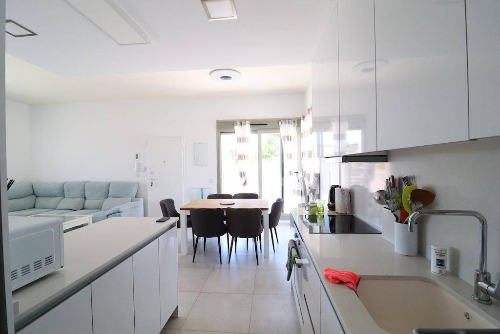 Open-plan kitchen with island unit and living room in furnished villa, Bellavista