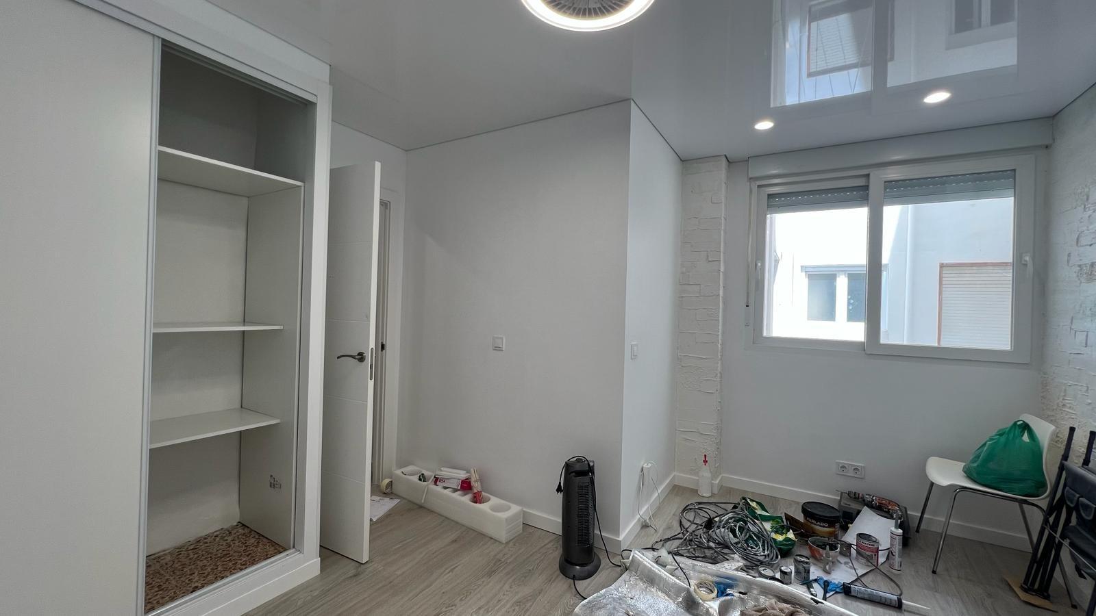 Open-plan kitchen with modern white units in renovated apartment, Acequion, Torrevieja