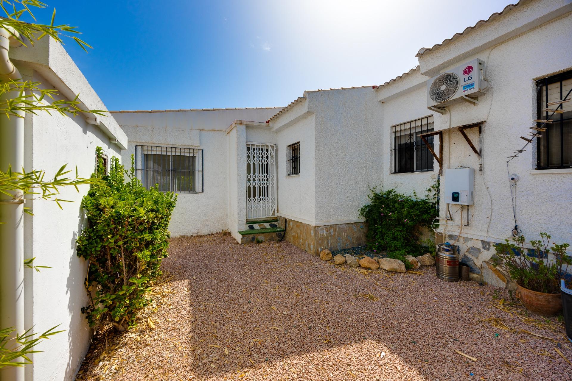 Garden path and planted borders in La Siesta villa, Torrevieja