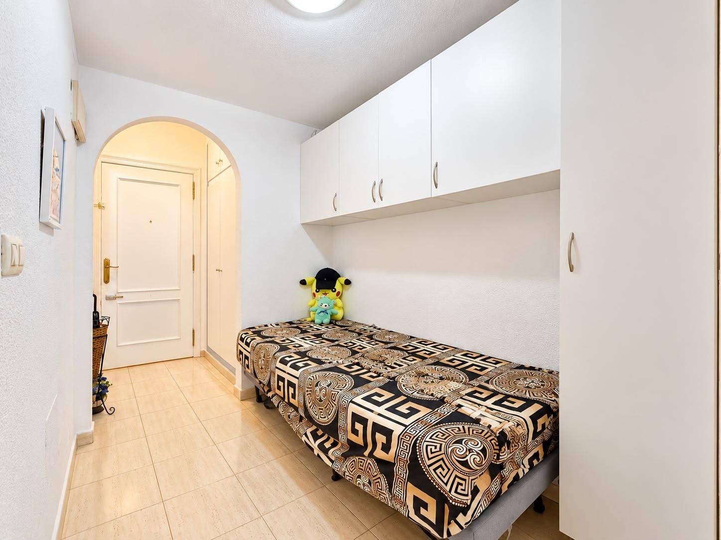 Sleeping area with built-in wardrobes in studio apartment, Playa del Cura