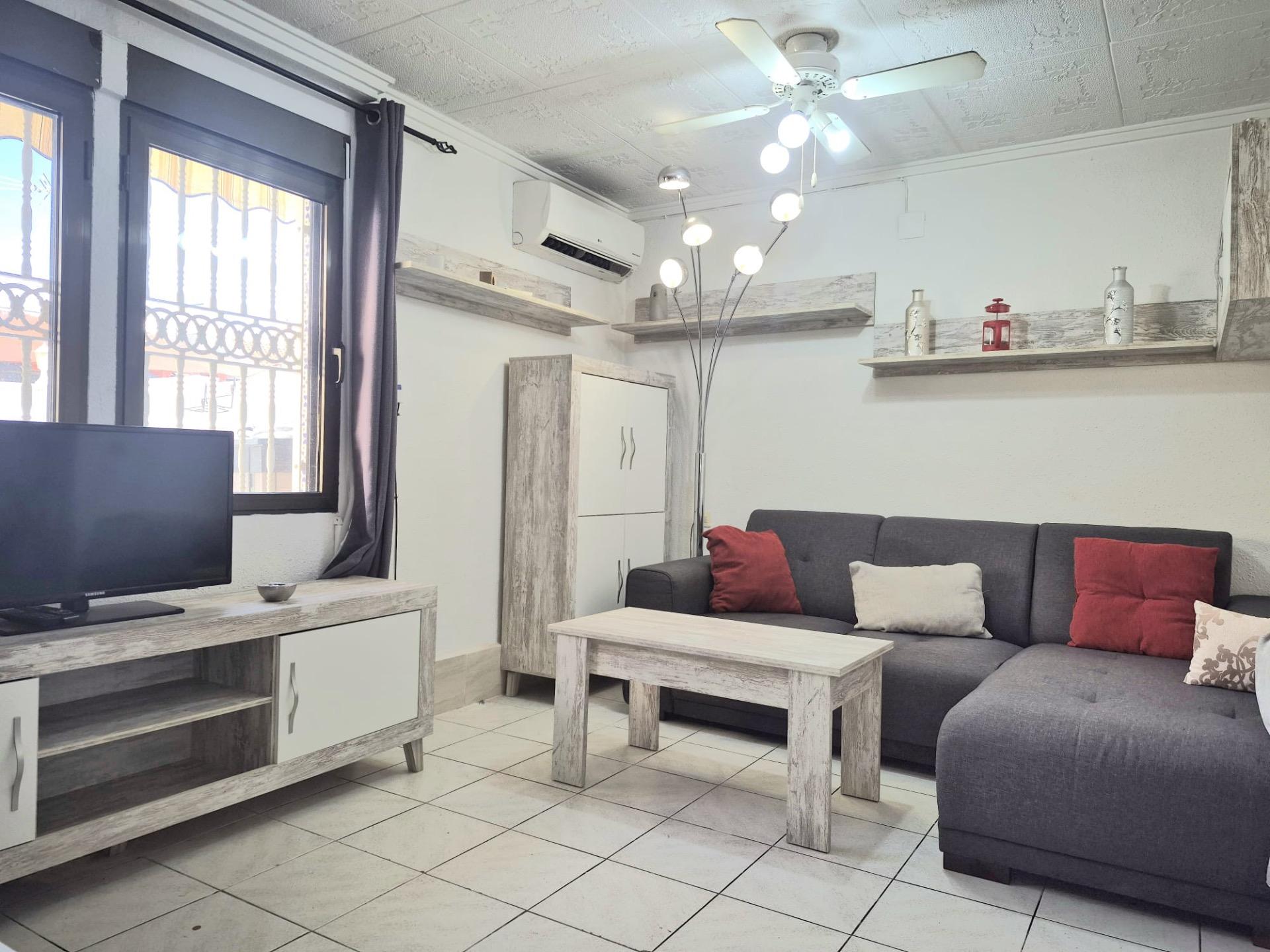 Living room with air conditioning unit in bungalow, Torretas, Torrevieja