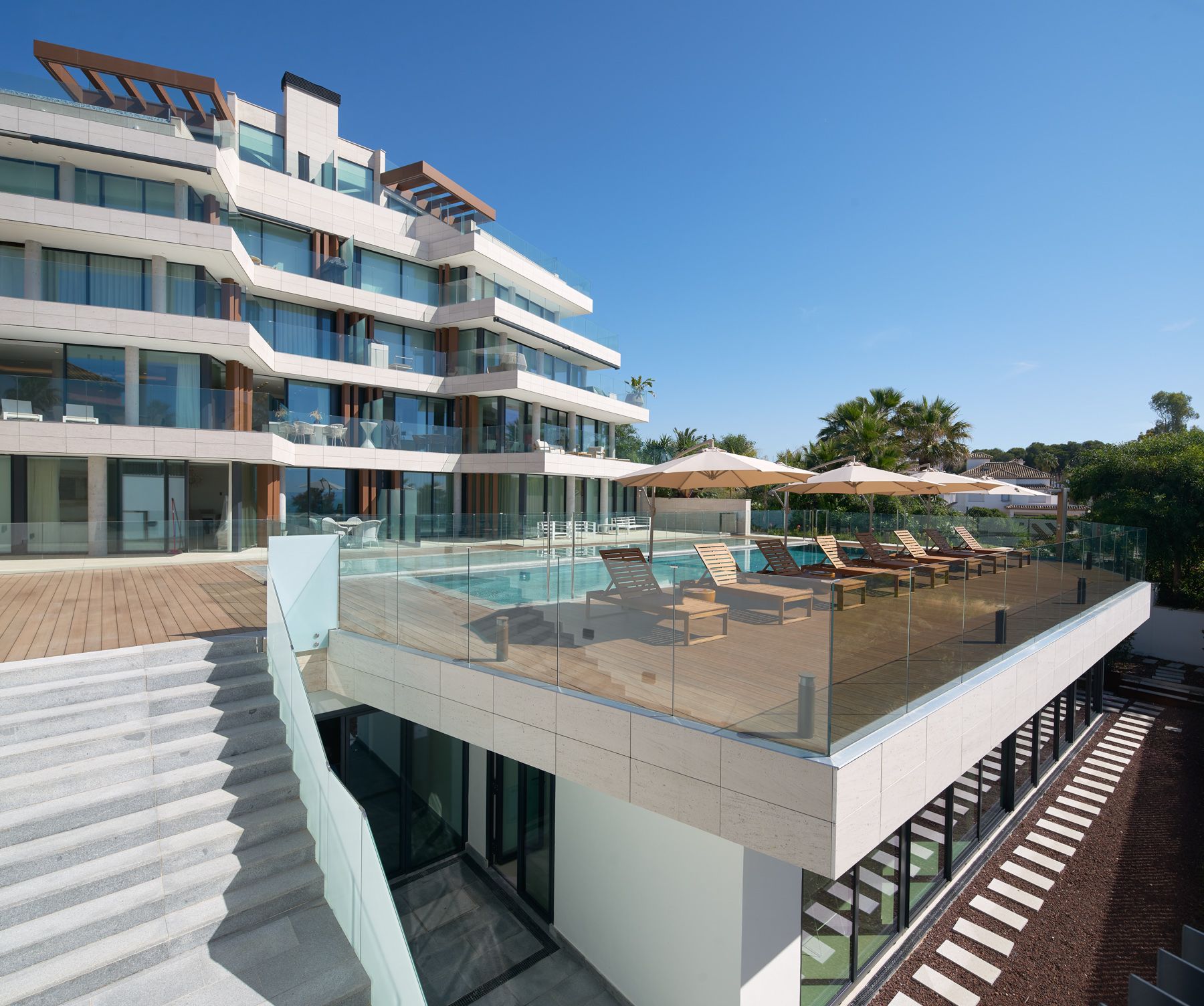 Communal pool and surrounding terrace area in new-build development, Guadalobón, Estepona