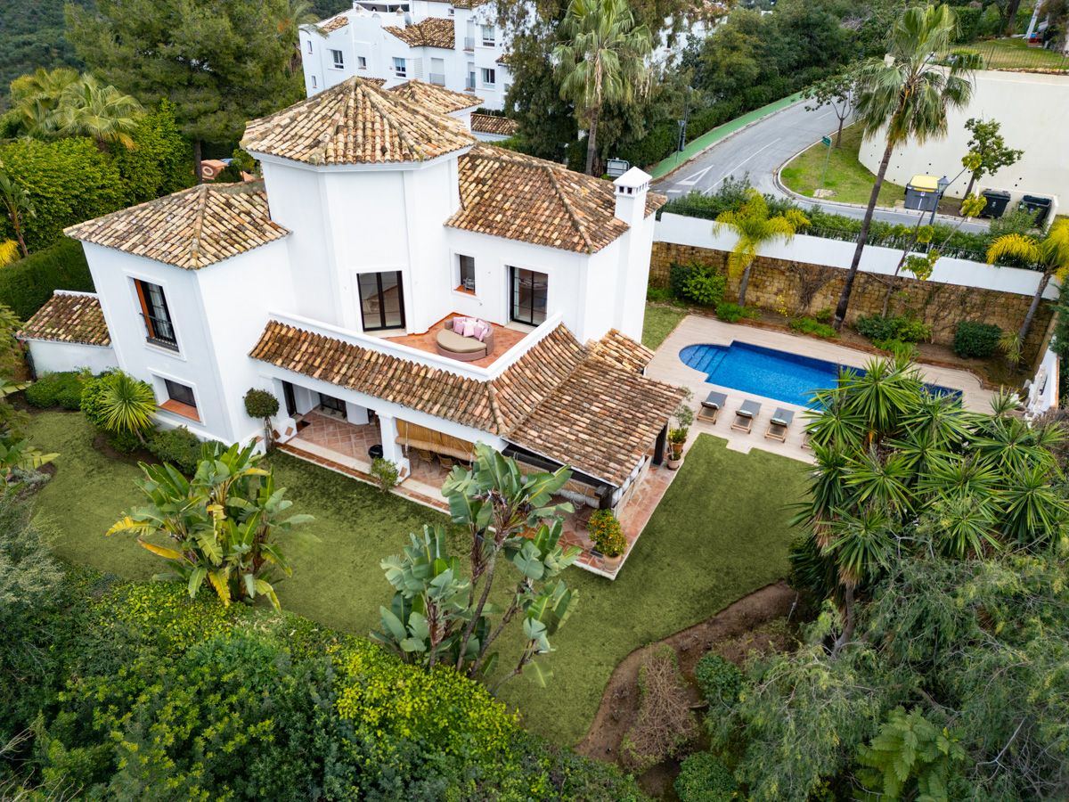 Pool and landscaped garden viewed from villa terrace, La Quinta, Benahavis